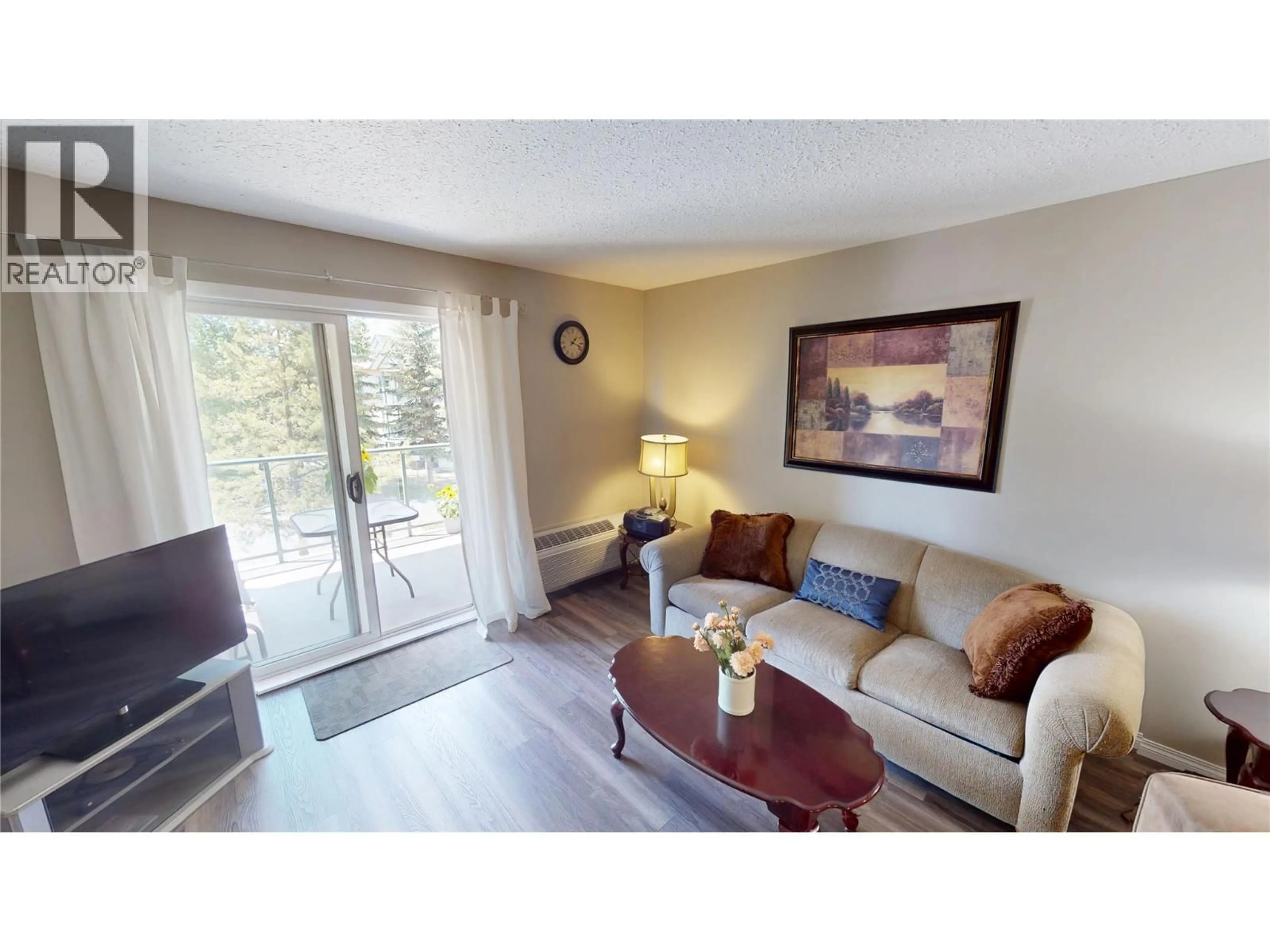 Living room with furniture, wood/laminate floor for 209 - 4769 FORSTERS LANDING ROAD, Radium Hot Springs British Columbia V0A1M0