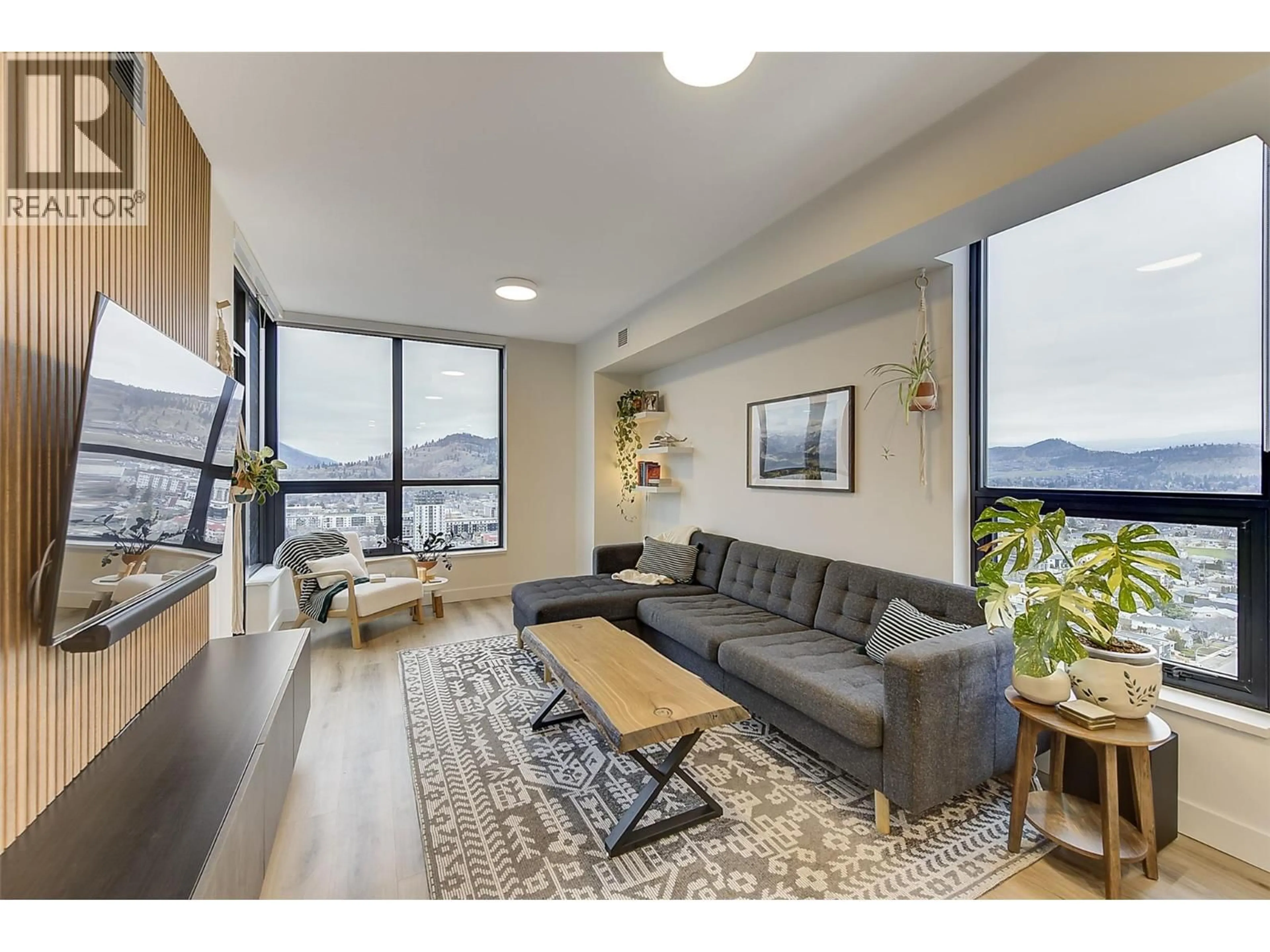 Living room with furniture, wood/laminate floor for 2508 - 1488 BERTRAM STREET, Kelowna British Columbia V1Y0M6