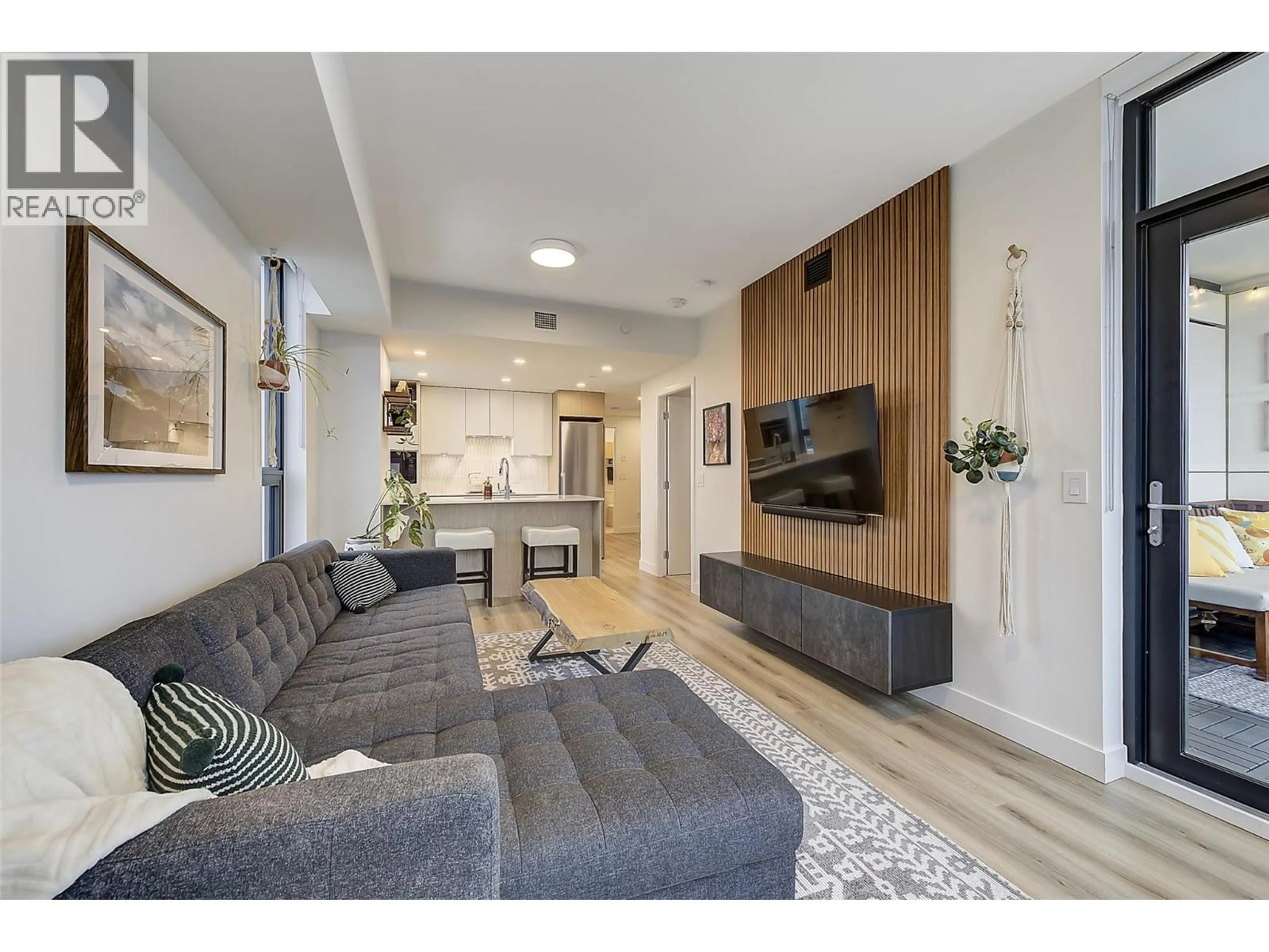 Living room with furniture, wood/laminate floor for 2508 - 1488 BERTRAM STREET, Kelowna British Columbia V1Y0M6
