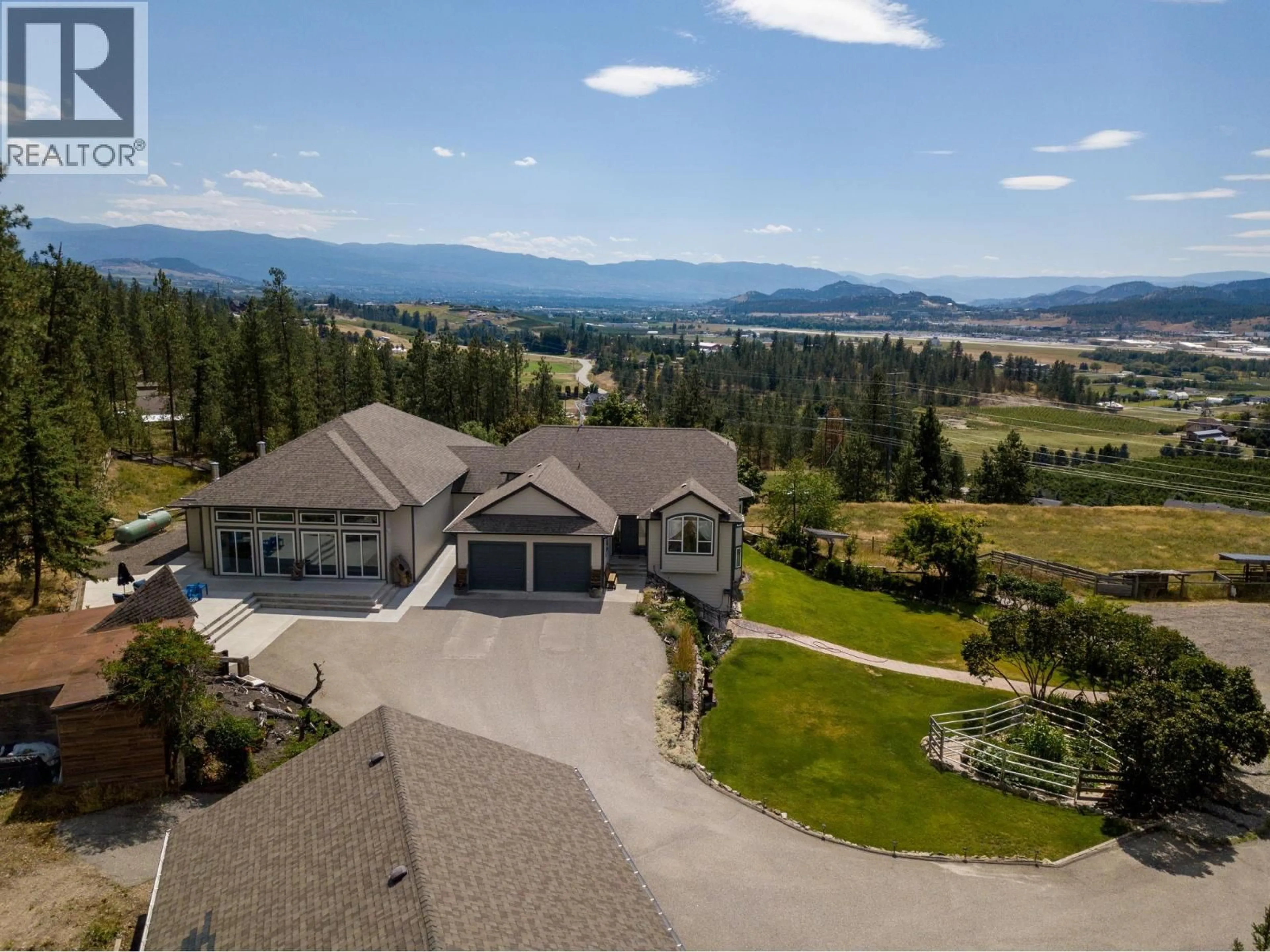 A pic from outside/outdoor area/front of a property/back of a property/a pic from drone, mountain view for 5955 POSTILL LAKE ROAD, Kelowna British Columbia V1X7V3