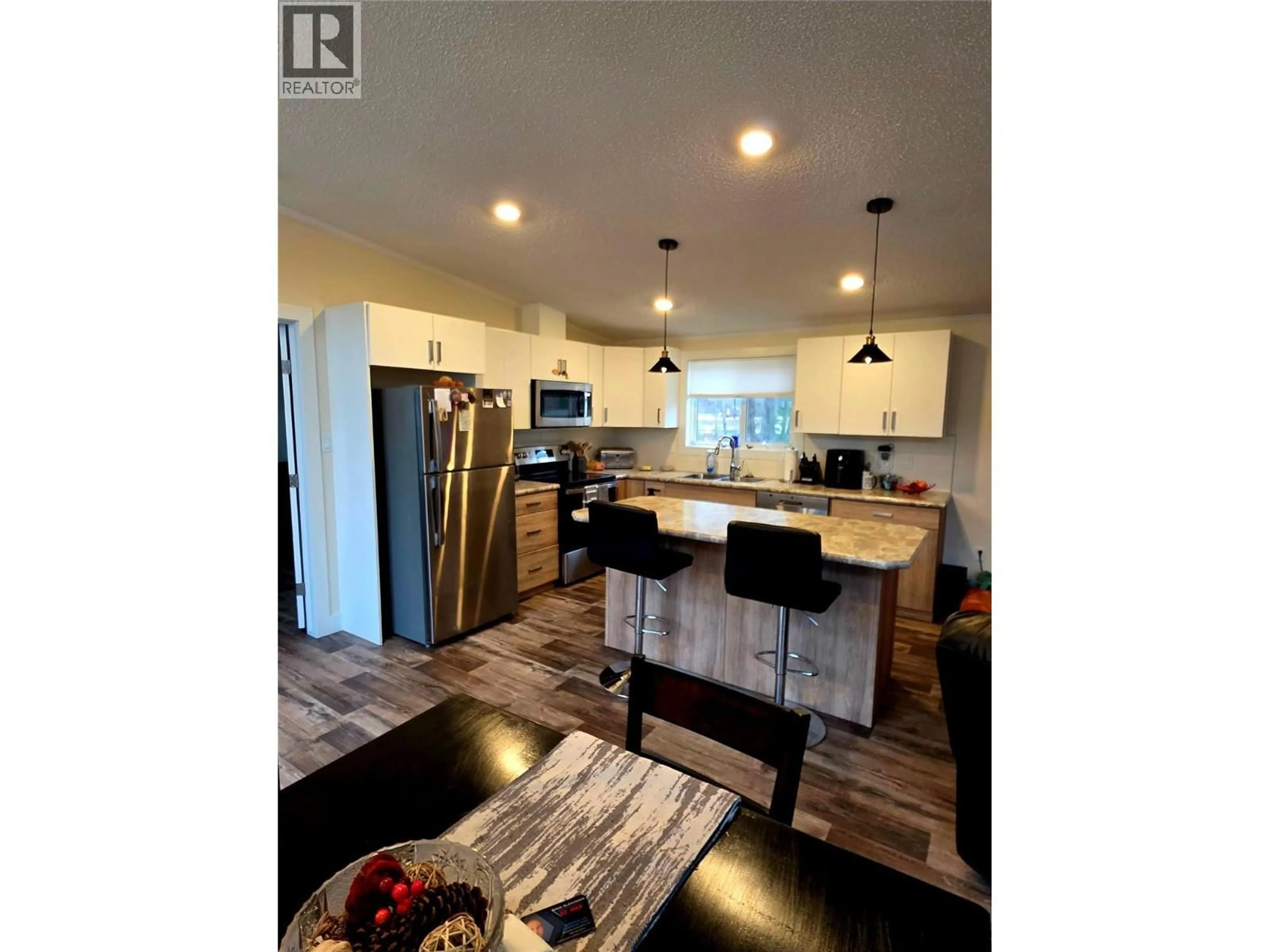 Open concept kitchen, wood/laminate floor for 235 AYLMER ROAD, Chase British Columbia V0E1M1