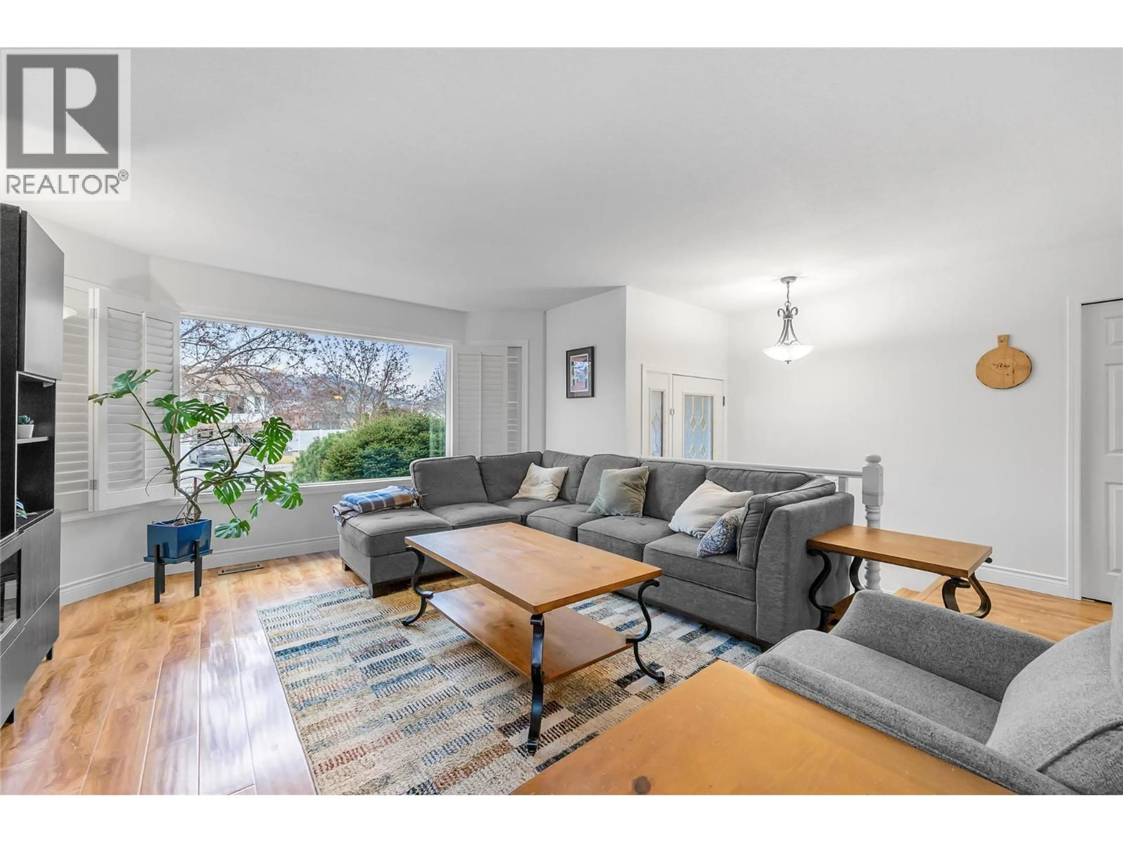 Living room with furniture, wood/laminate floor for 232 MOUBRAY ROAD, Kelowna British Columbia V1V1S4