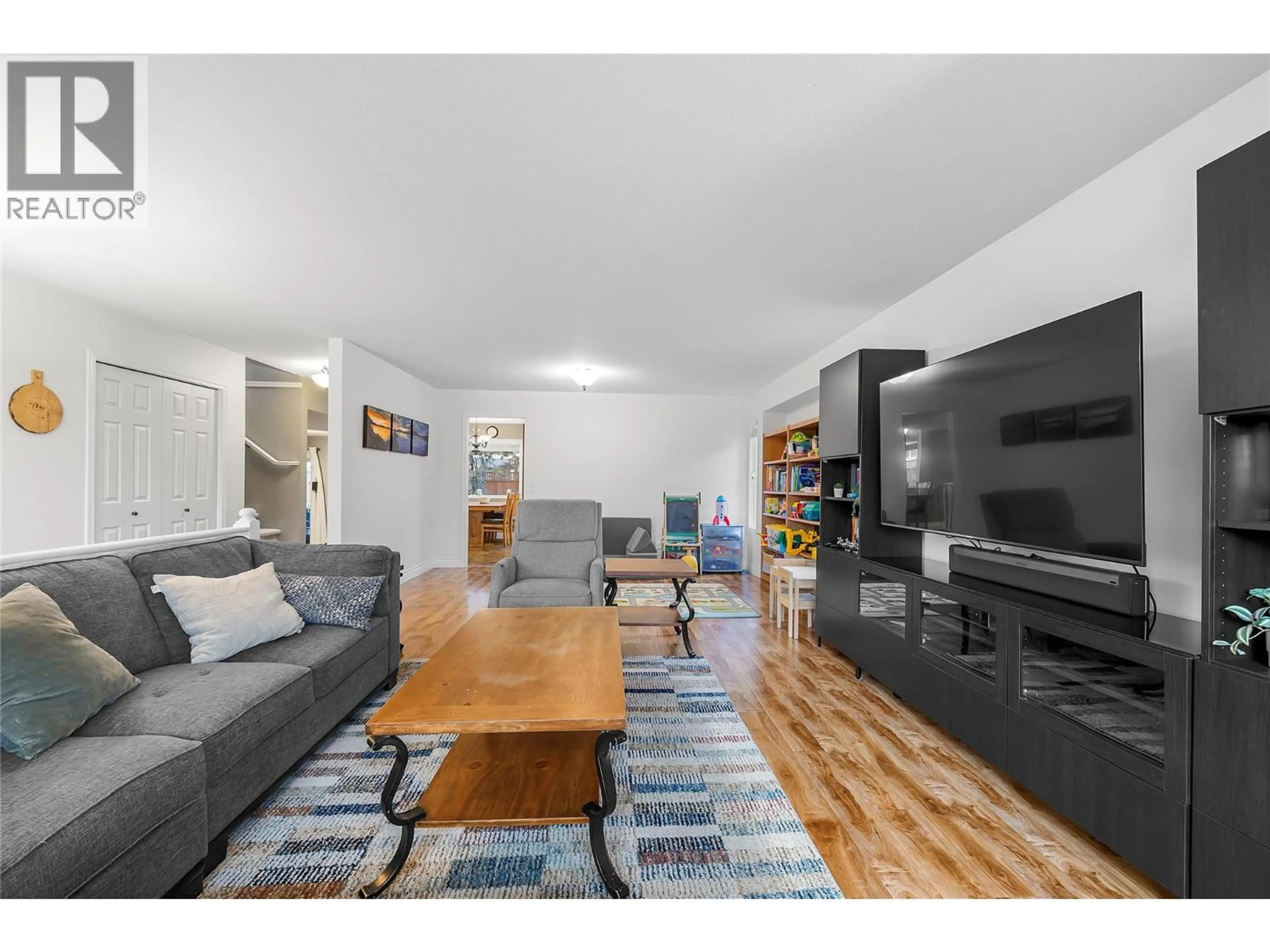 Living room with furniture, wood/laminate floor for 232 MOUBRAY ROAD, Kelowna British Columbia V1V1S4