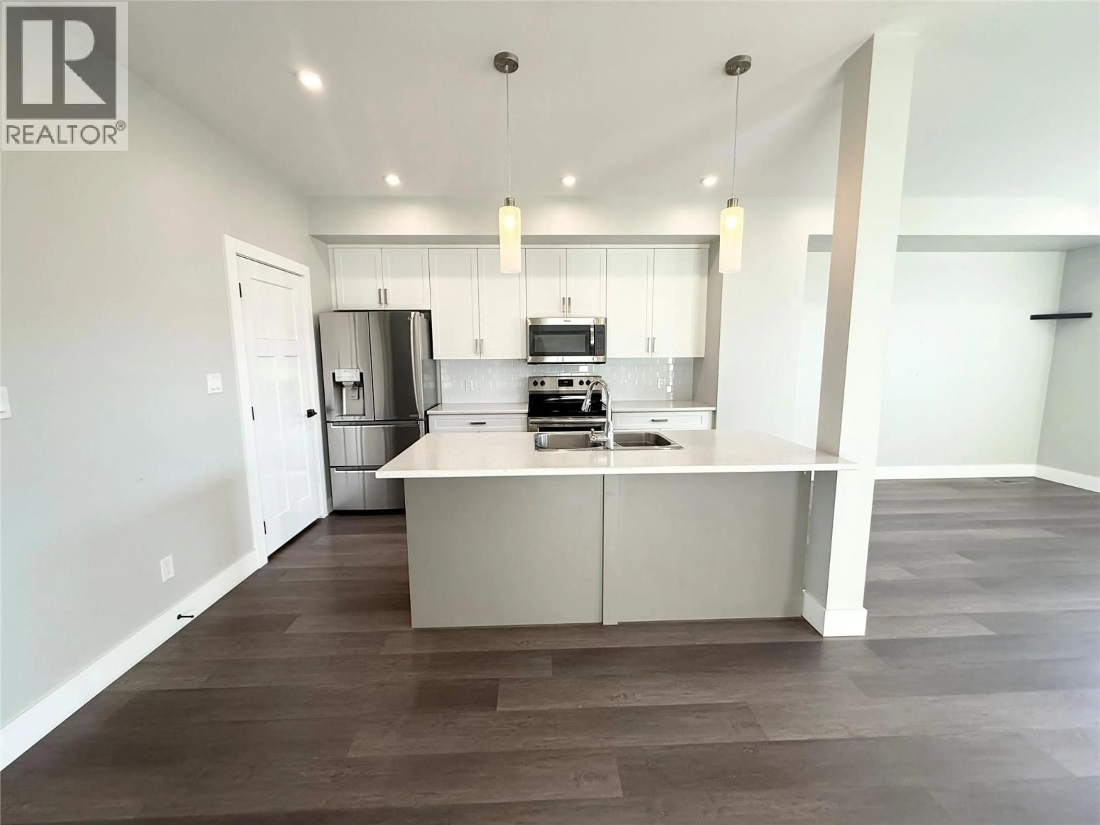 Open concept kitchen, wood/laminate floor for 1611 PHILLIPS STREET, Merritt British Columbia V1K0B8