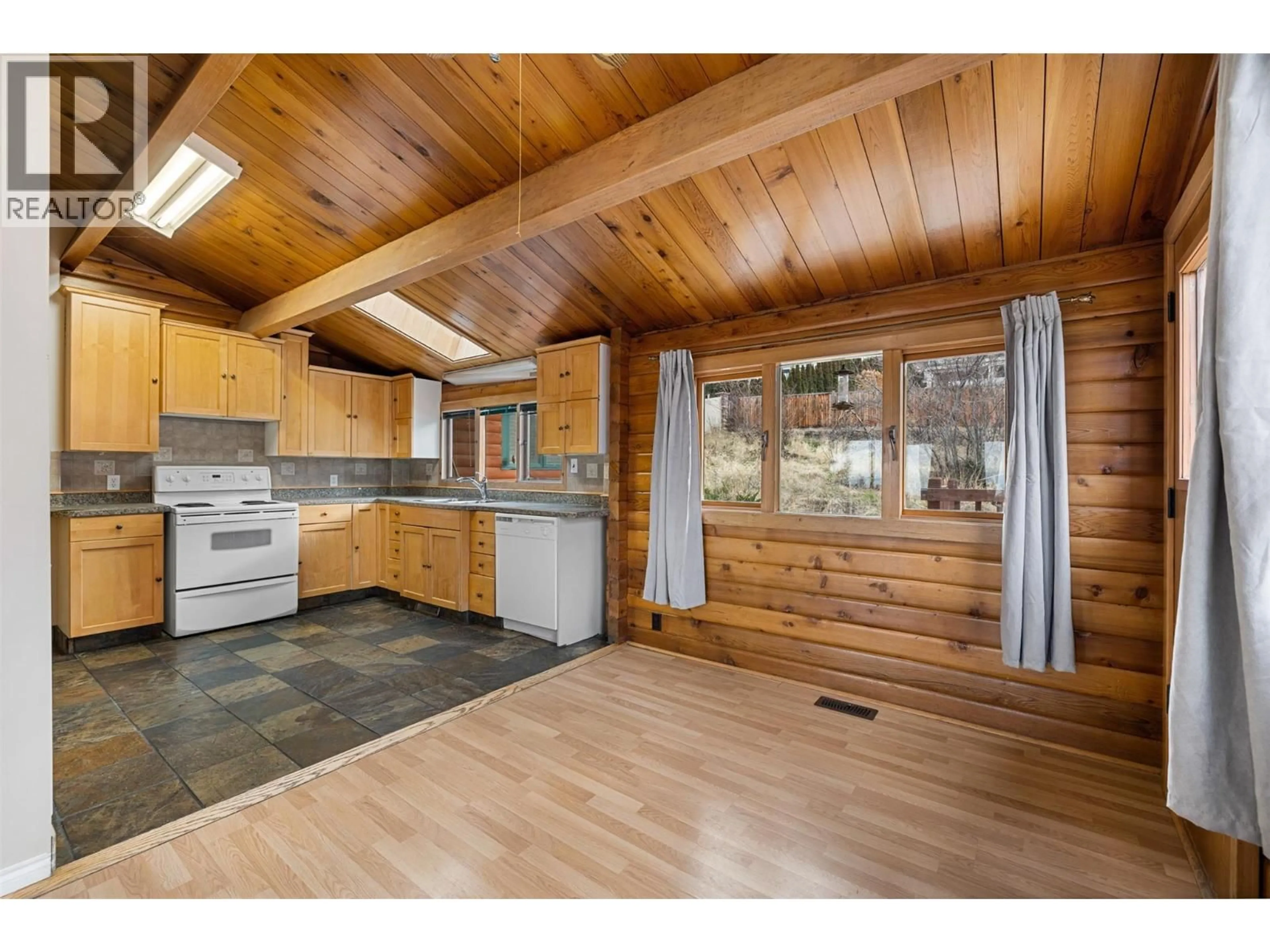 Open concept kitchen, wood/laminate floor for 5267 CHUTE LAKE ROAD, Kelowna British Columbia V1W4K8