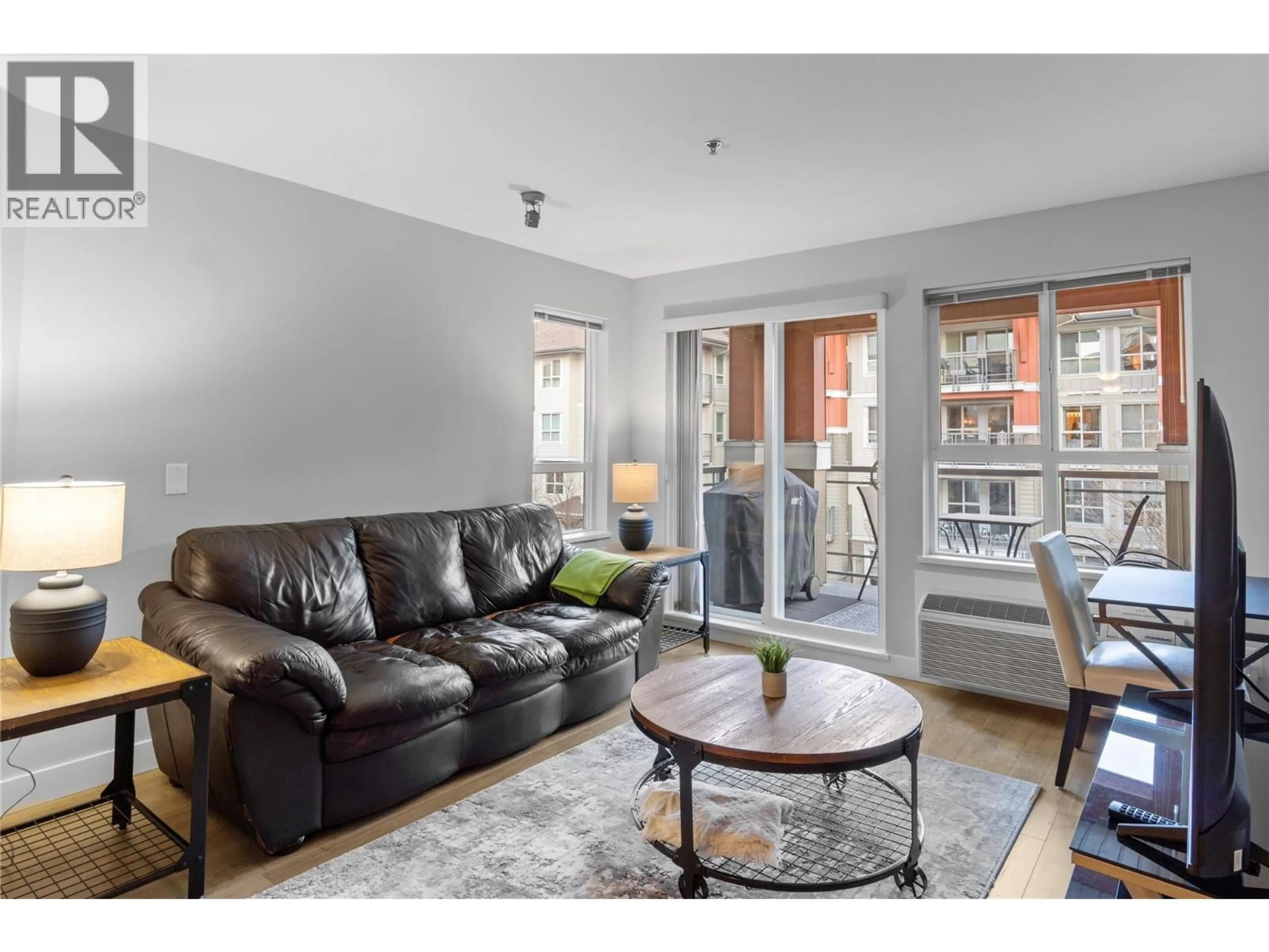 Living room with furniture, wood/laminate floor for 341 - 1099 SUNSET DRIVE, Kelowna British Columbia V1Y9Z2