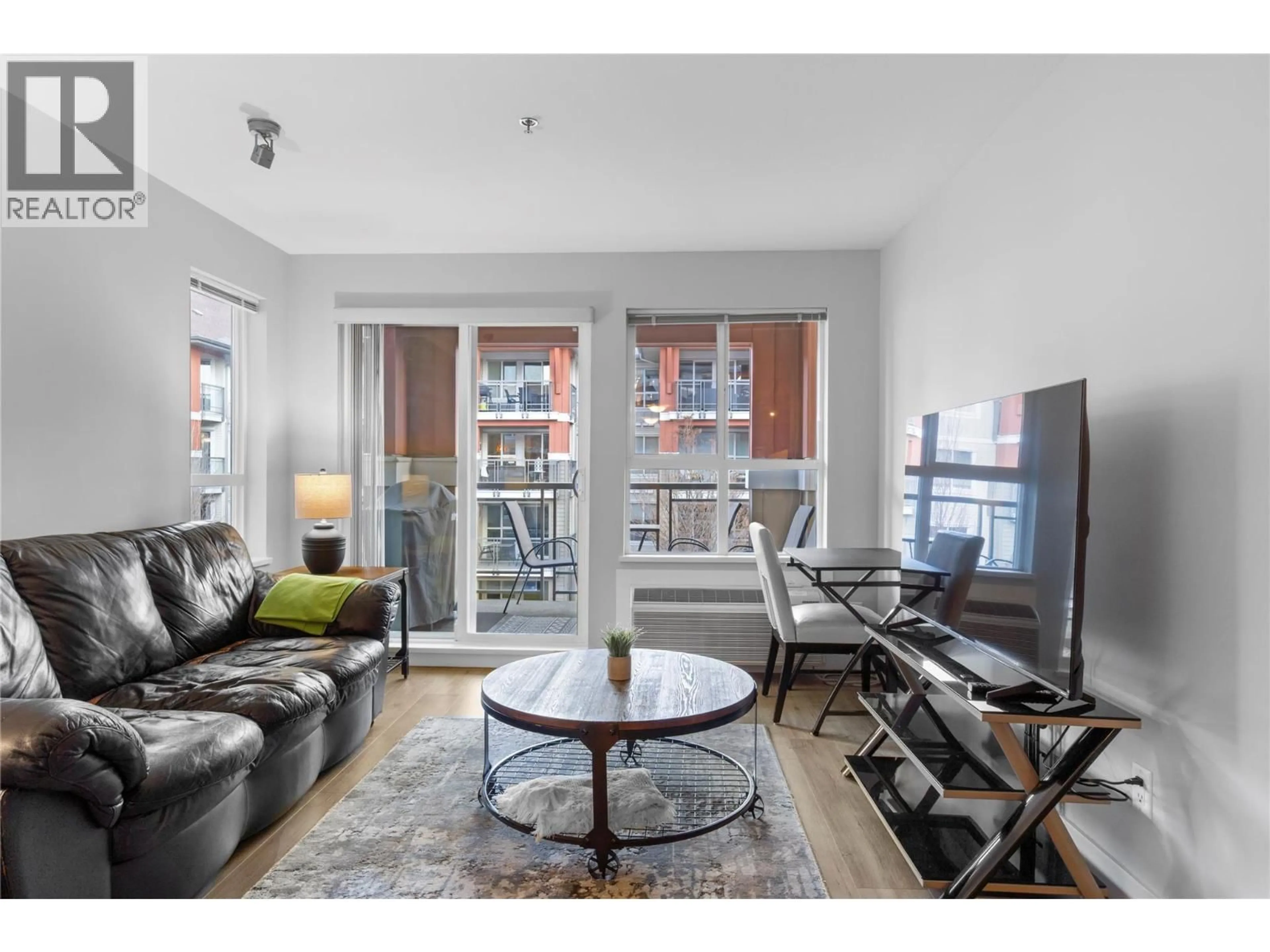 Living room with furniture, wood/laminate floor for 341 - 1099 SUNSET DRIVE, Kelowna British Columbia V1Y9Z2