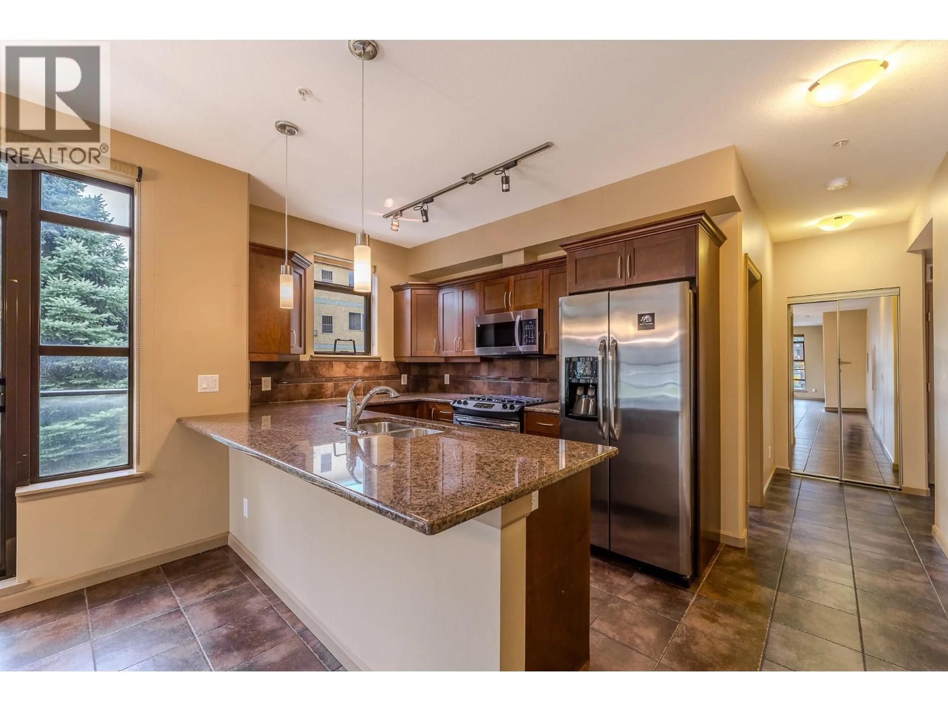 Open concept kitchen, ceramic/tile floor for 204 - 3589 SKAHA LAKE ROAD, Penticton British Columbia V2A7K2