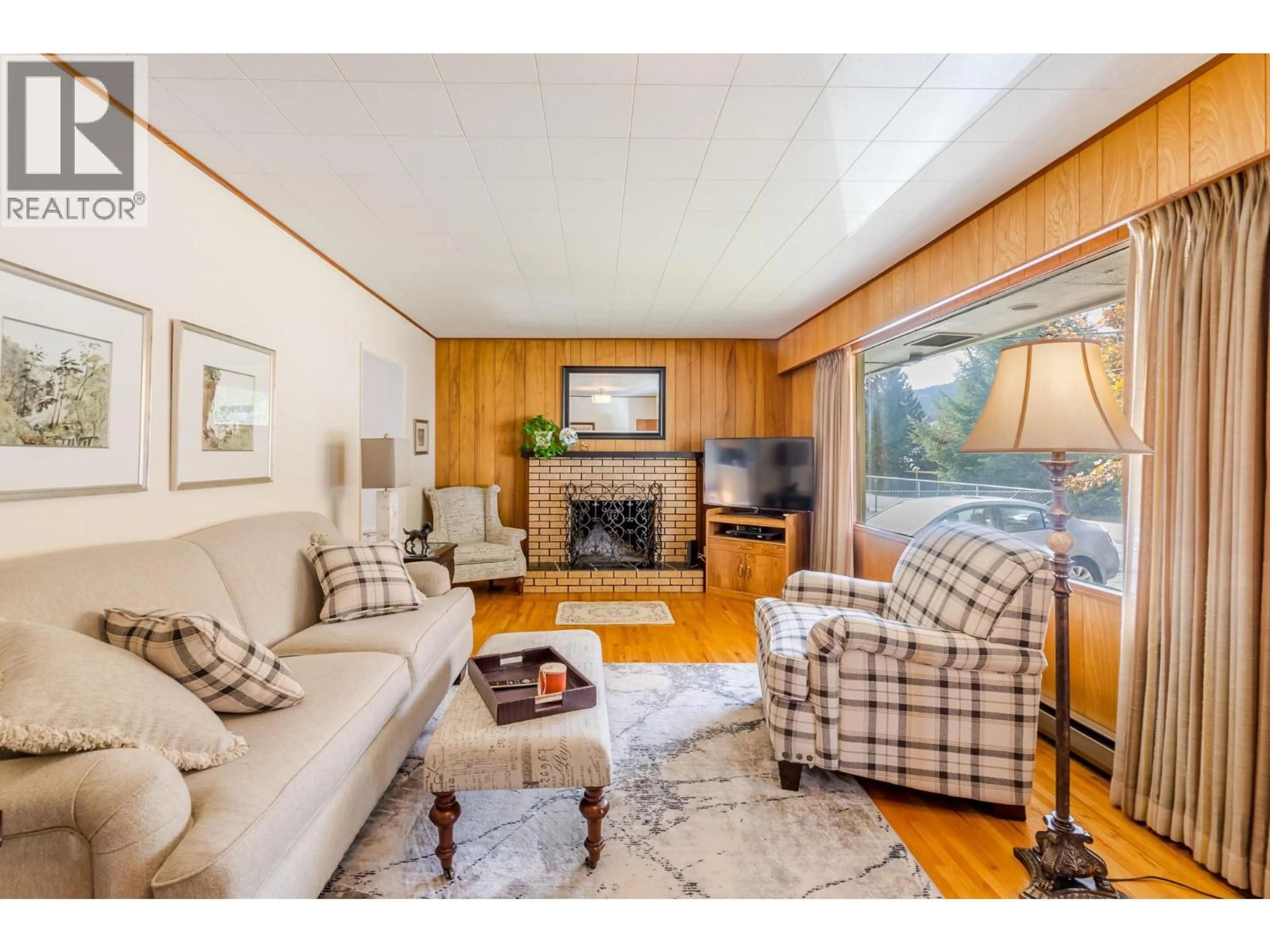 Living room with furniture, wood/laminate floor for 14001 AMM AVENUE, Summerland British Columbia V0H1Z0