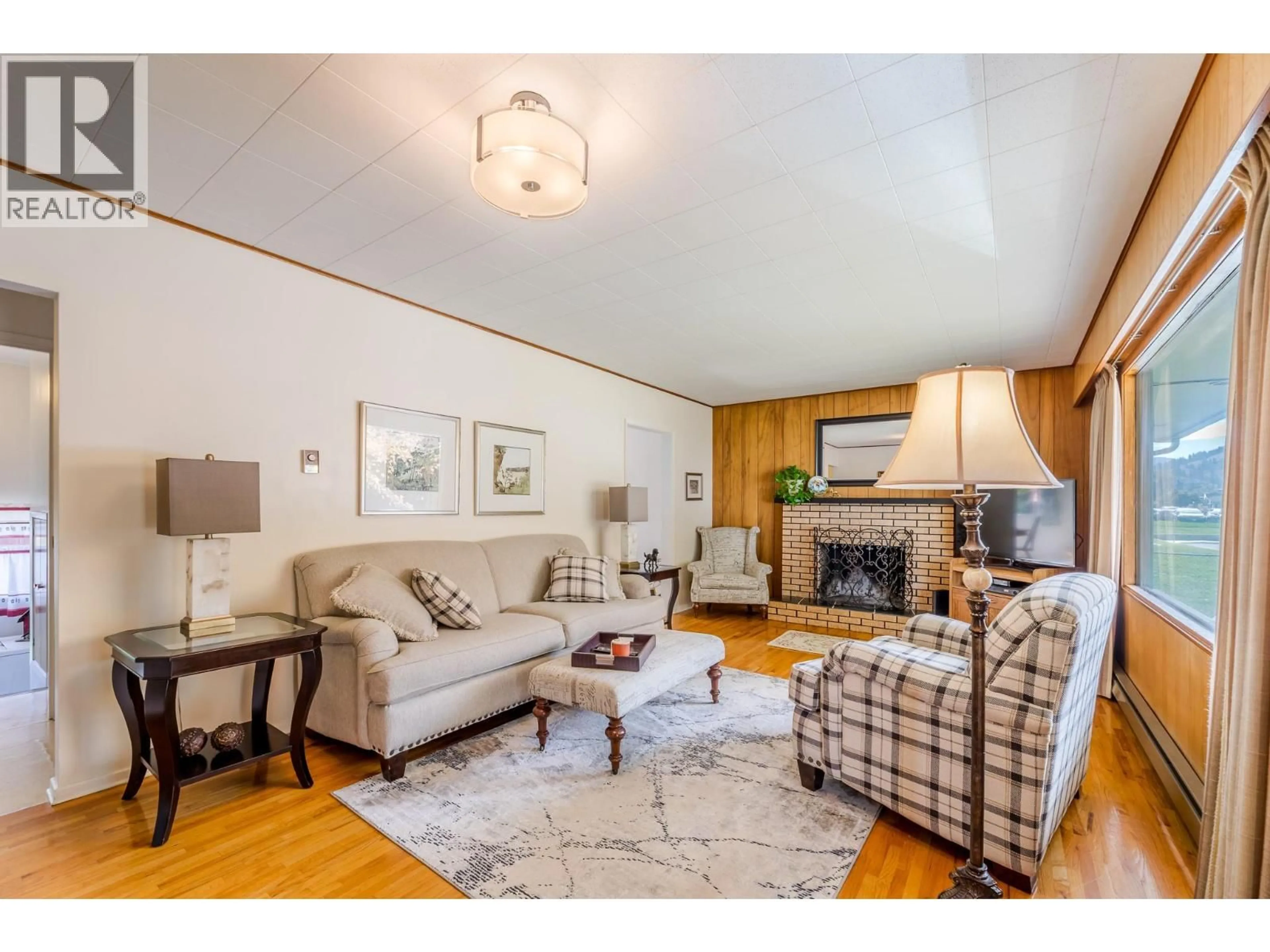 Living room with furniture, wood/laminate floor for 14001 AMM AVENUE, Summerland British Columbia V0H1Z0