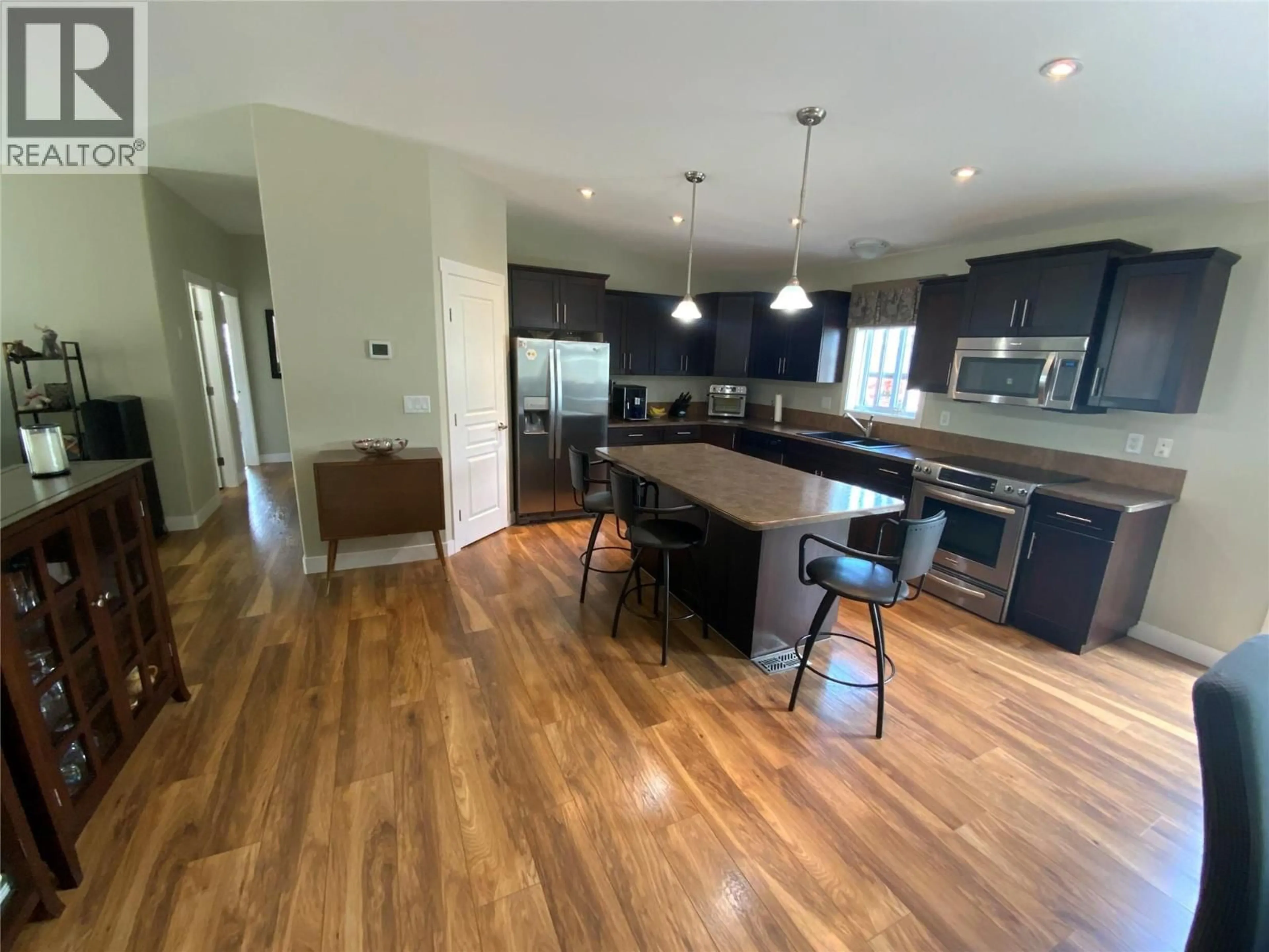 Open concept kitchen, wood/laminate floor for 69 - 8300 GALLAGHER LAKE FRONTAGE ROAD, Oliver British Columbia V0H1T2