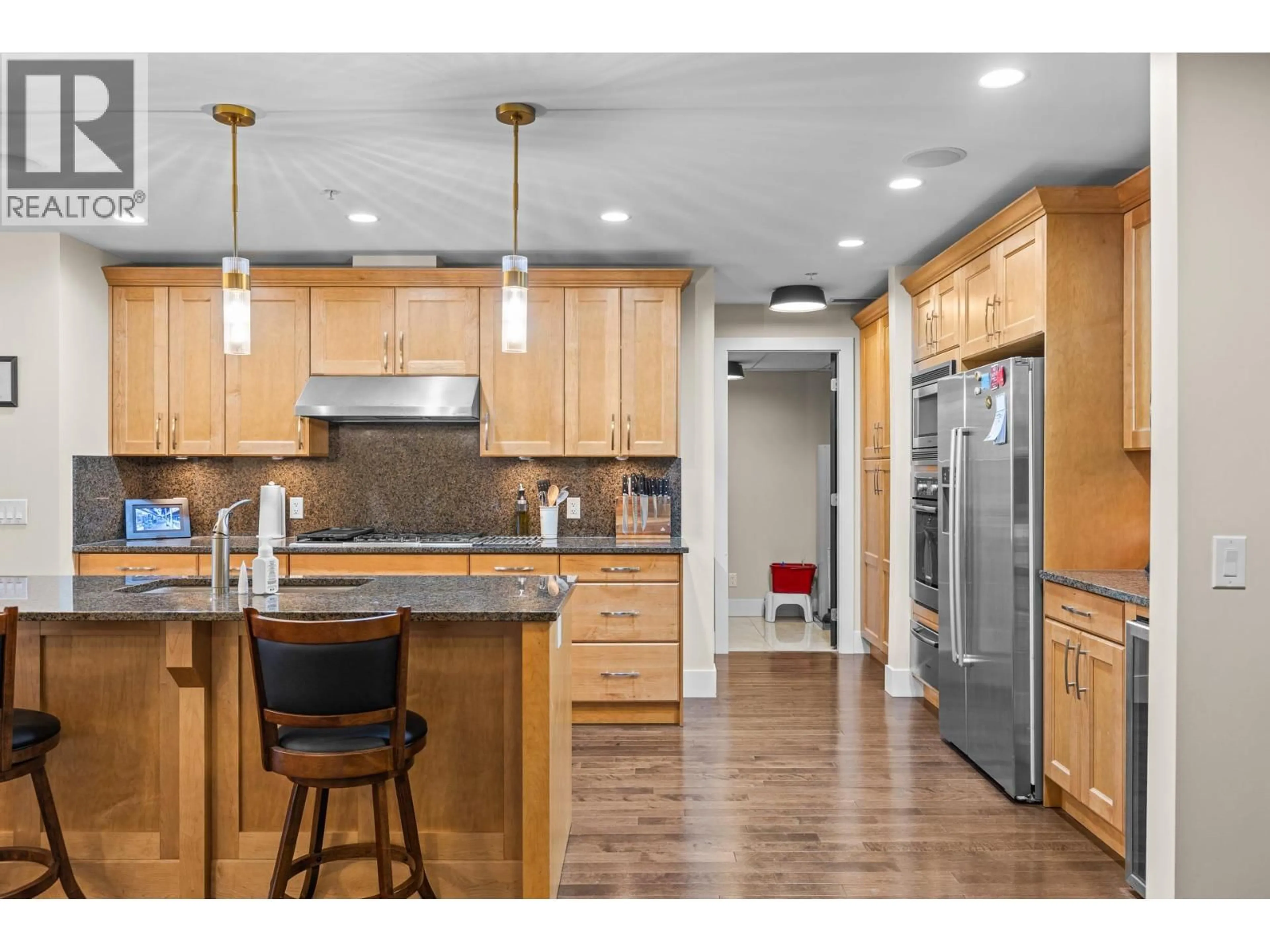 Open concept kitchen, wood/laminate floor for 506 - 1395 ELLIS STREET, Kelowna British Columbia V1Y1Z9