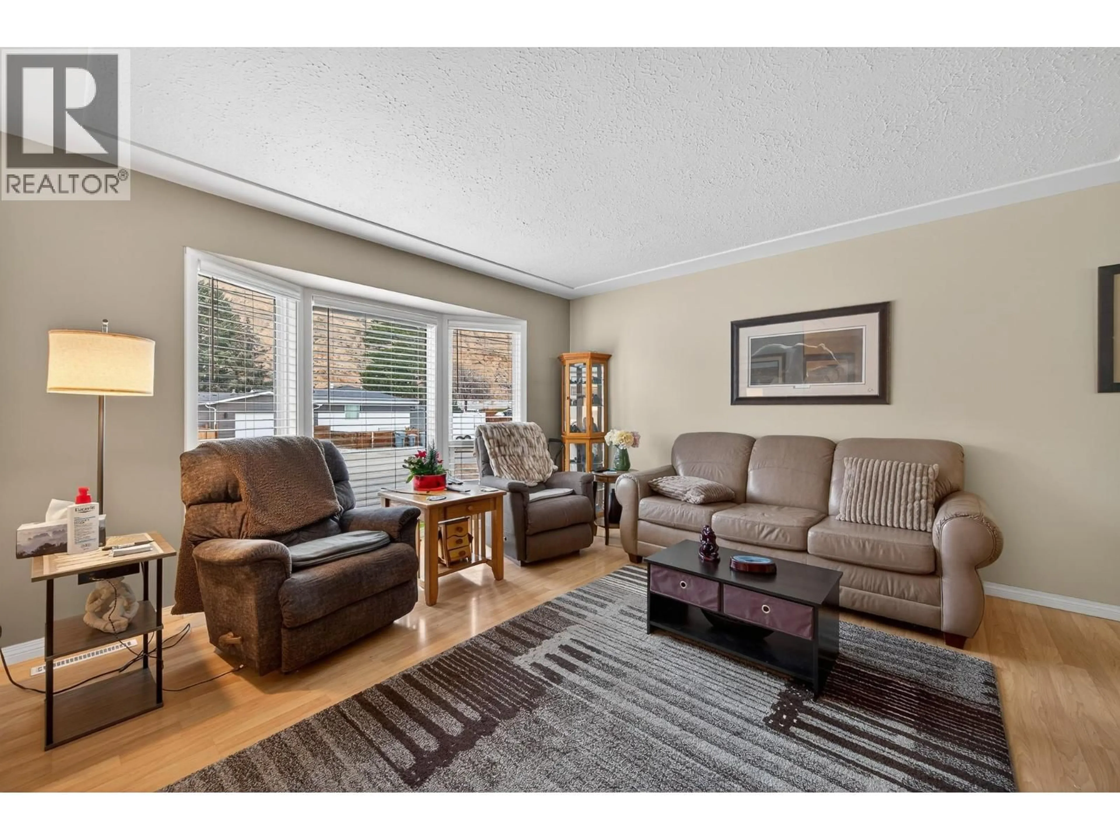 Living room with furniture, wood/laminate floor for 2331 BRIARWOOD AVENUE, Kamloops British Columbia V2B4Z6