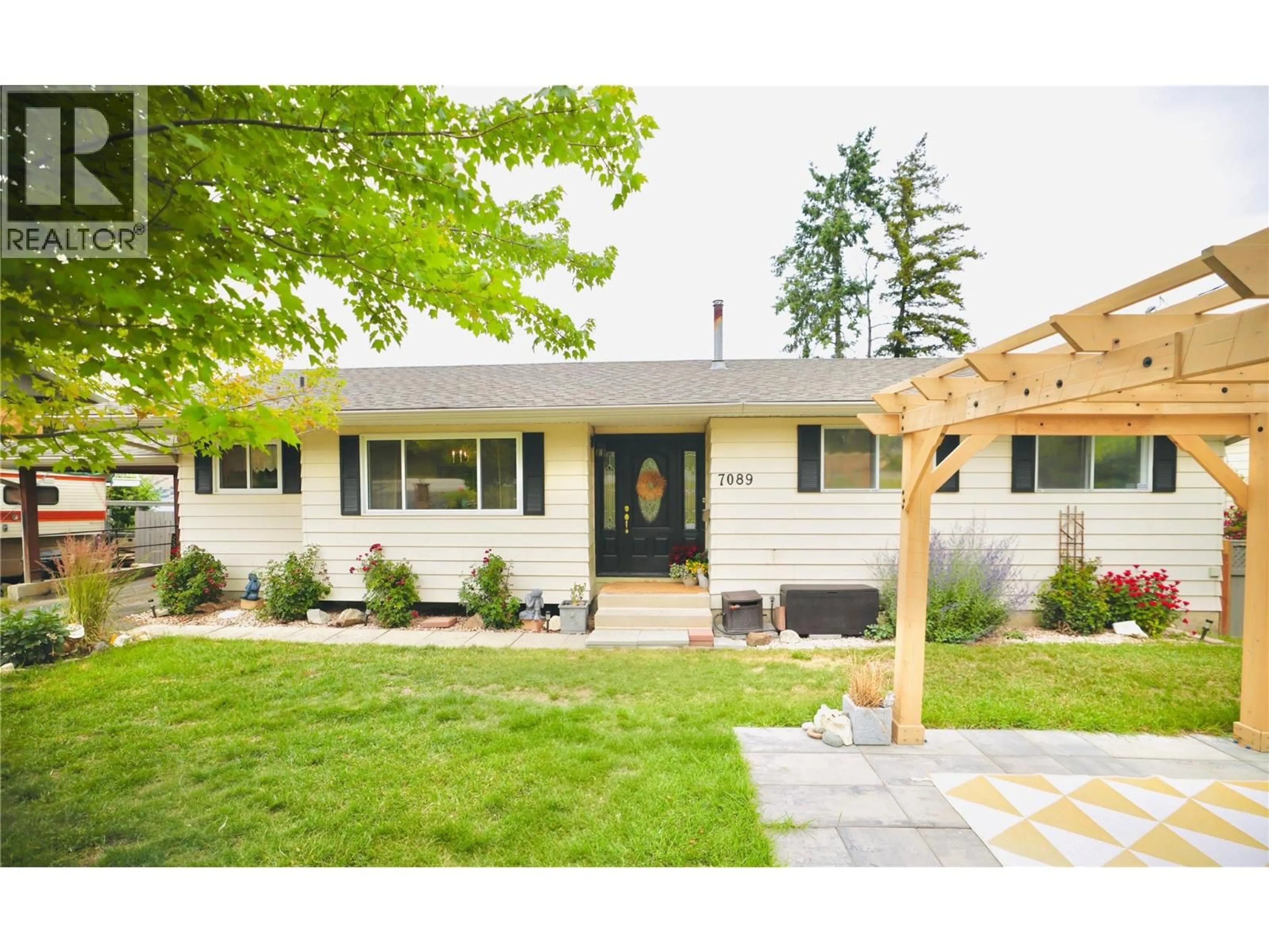 Home with vinyl exterior material, street for 7089 LONGACRE DRIVE, Vernon British Columbia V1H1H8