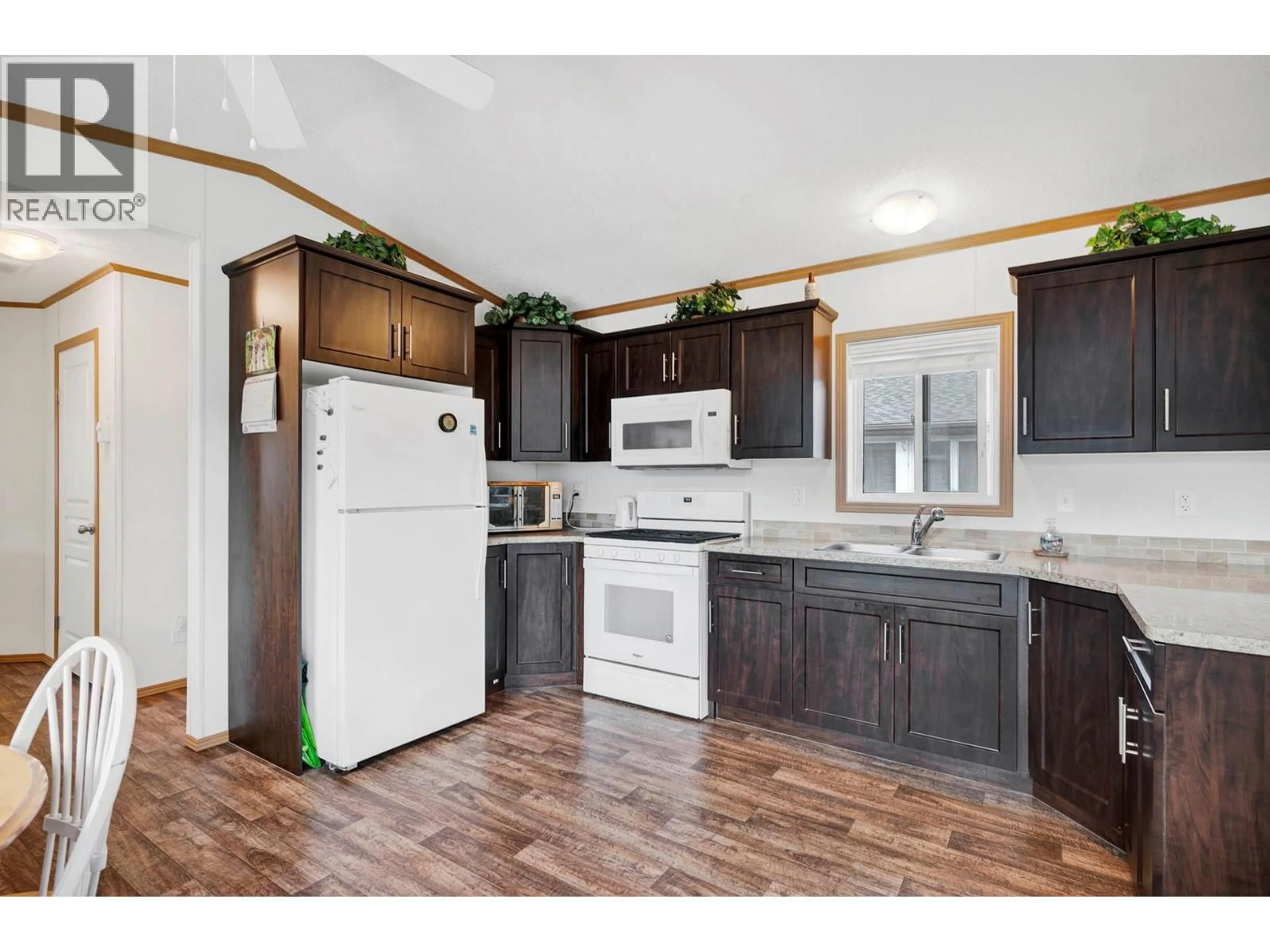 Open concept kitchen, wood/laminate floor for 1317 BOSTOCK CRESCENT, Pritchard British Columbia V0E2P0