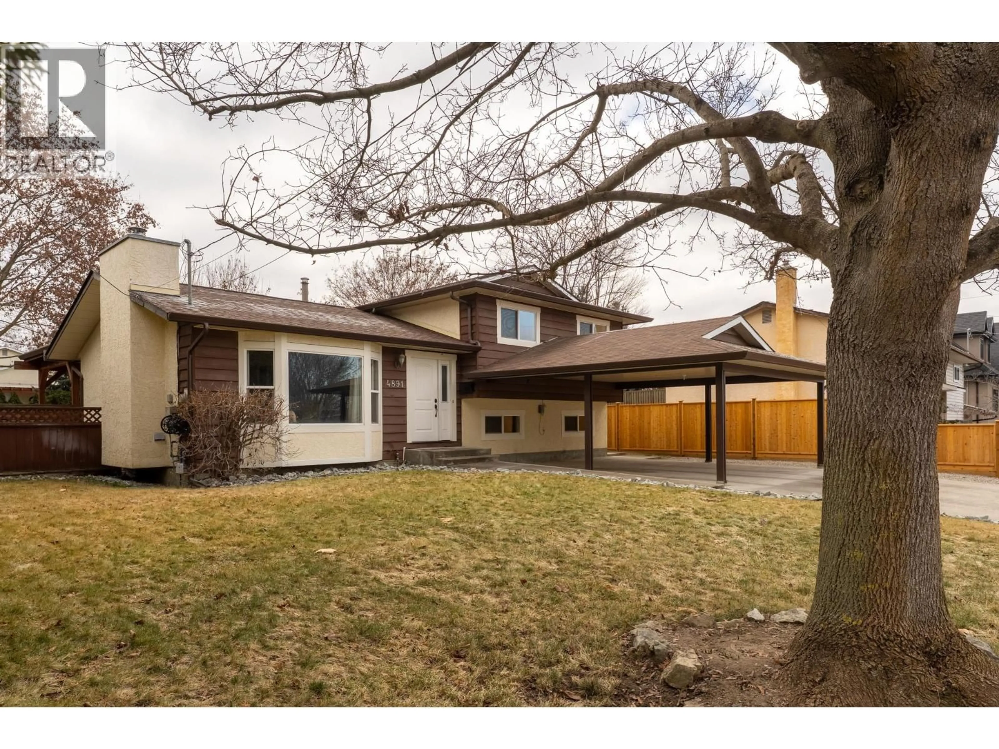 Home with vinyl exterior material, street for 4891 BULMAN ROAD, Ellison British Columbia V1X6S7