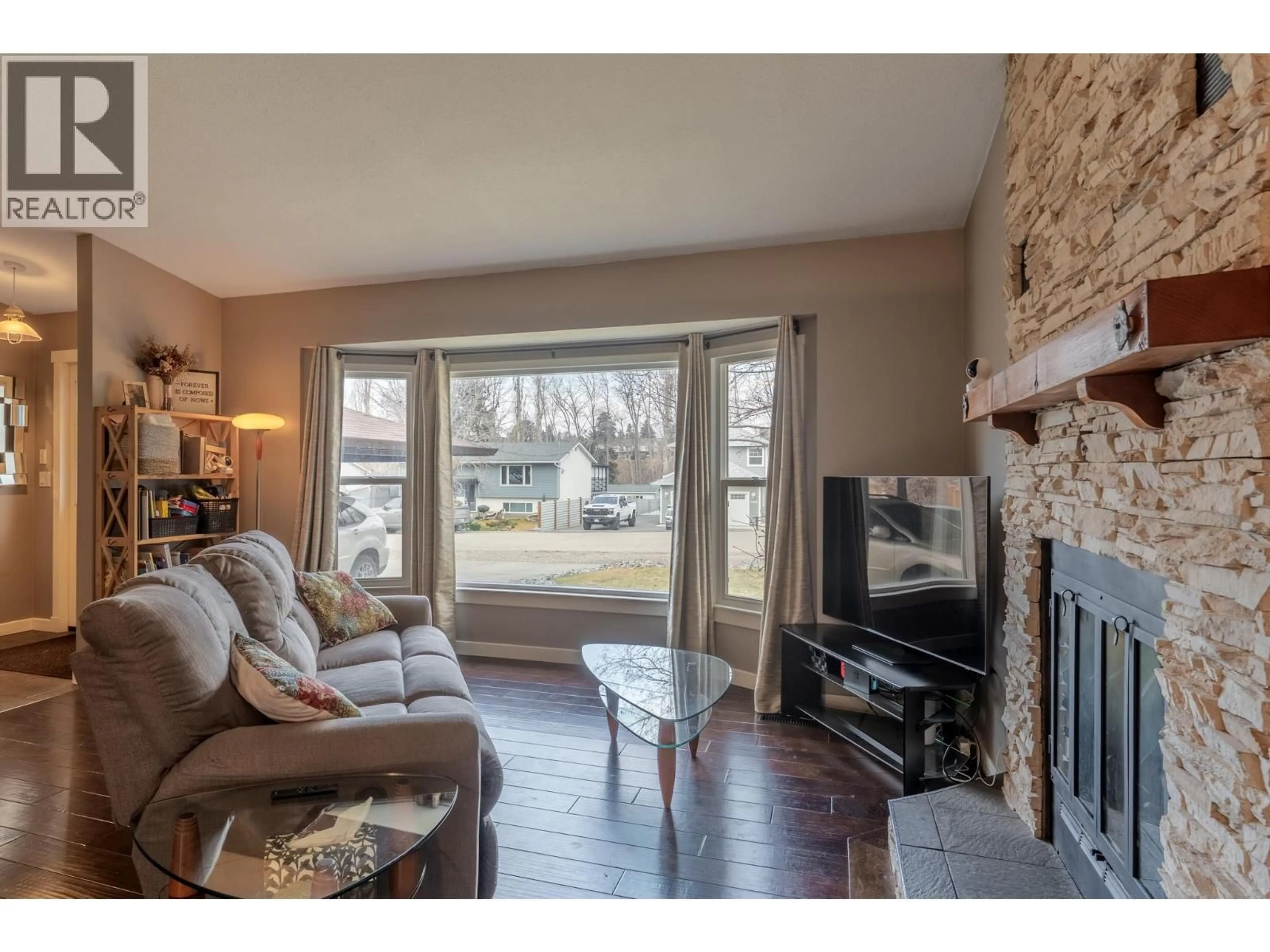 Living room with furniture, wood/laminate floor for 4891 BULMAN ROAD, Ellison British Columbia V1X6S7