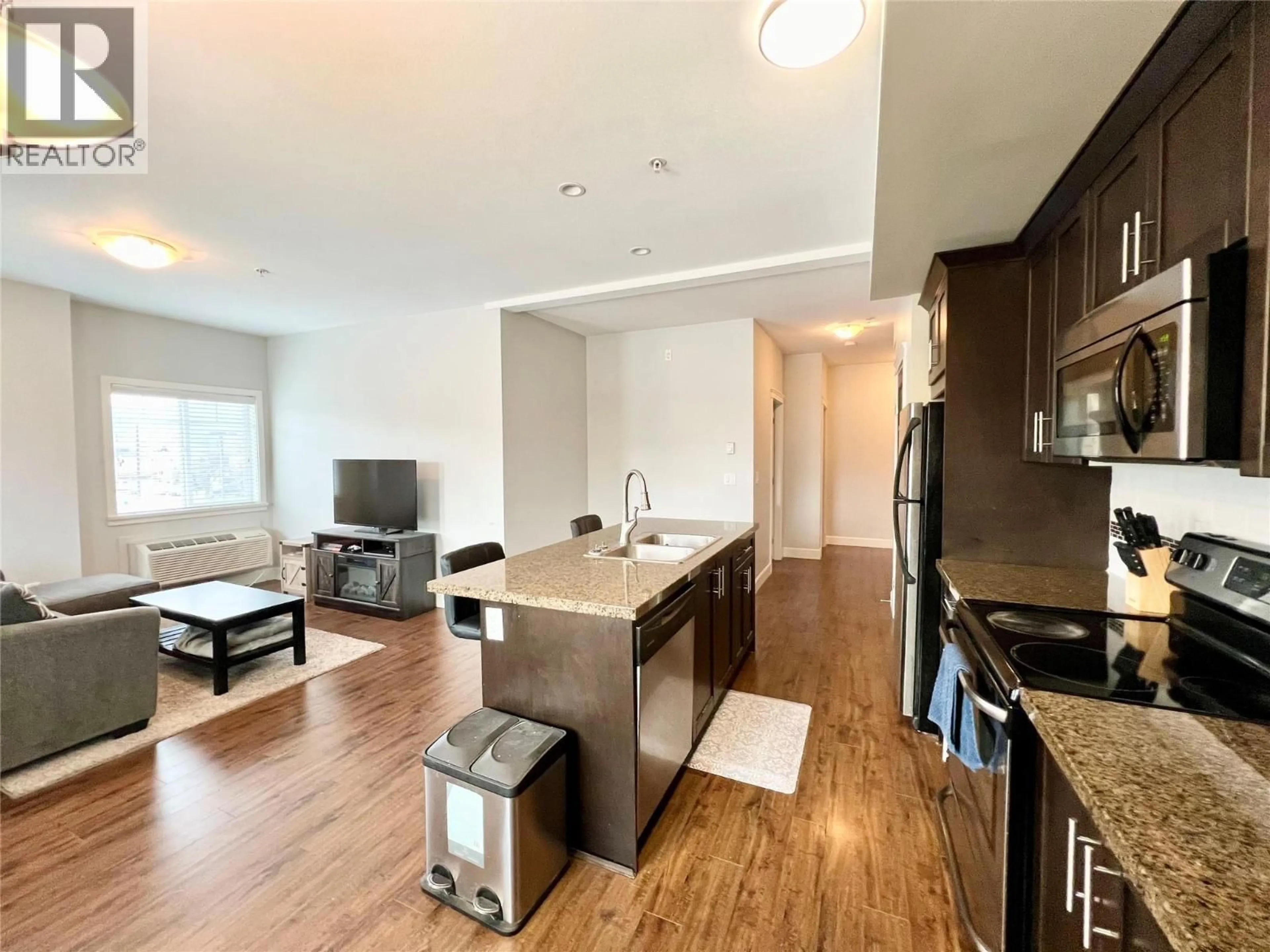 Open concept kitchen, wood/laminate floor for 206 - 2799 CLAPPERTON AVENUE, Merritt British Columbia V1K1A2