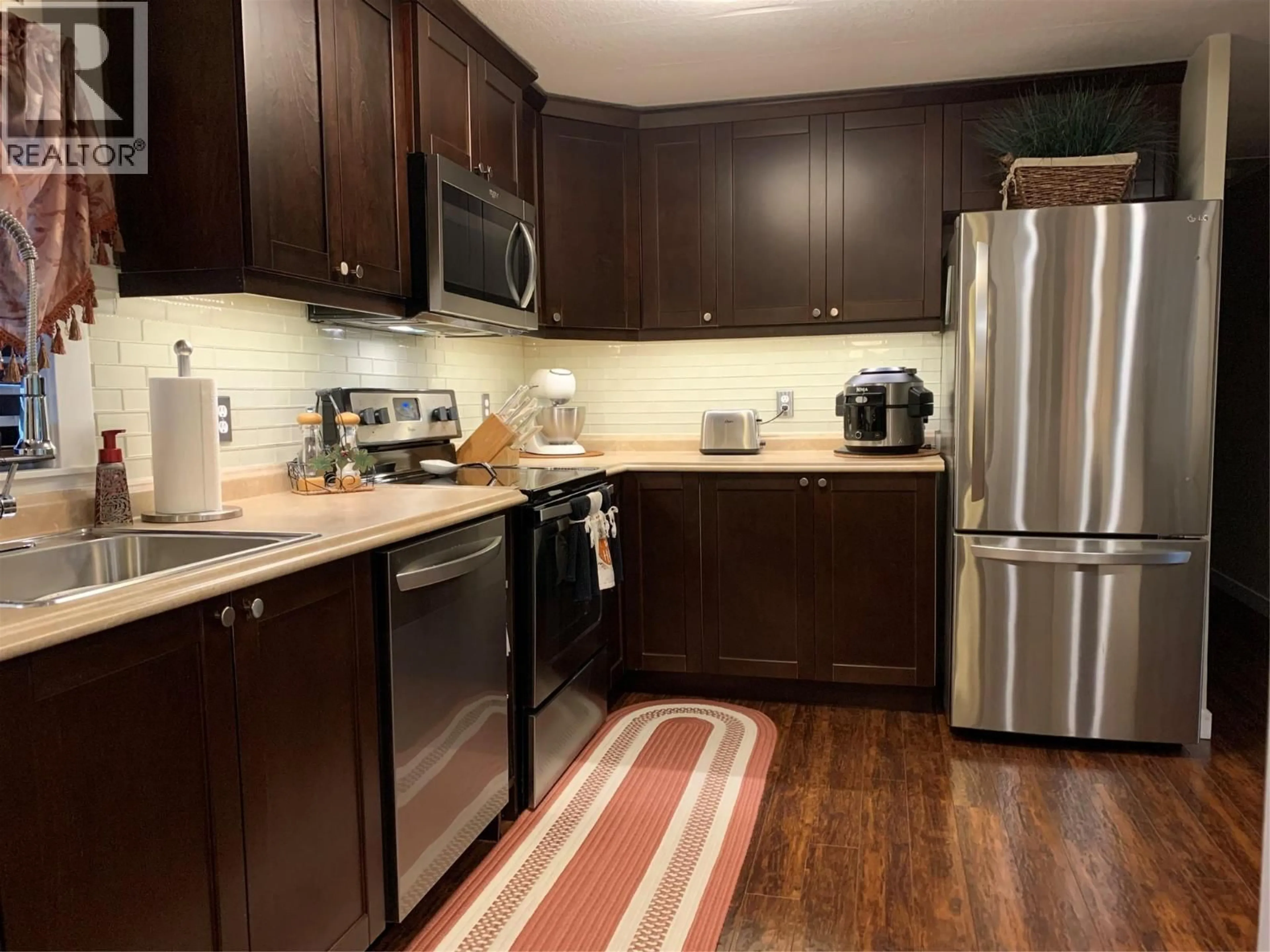 Standard kitchen, wood/laminate floor for 201 - 1999 HWY 97 OTHER, West Kelowna British Columbia V1Z1B2