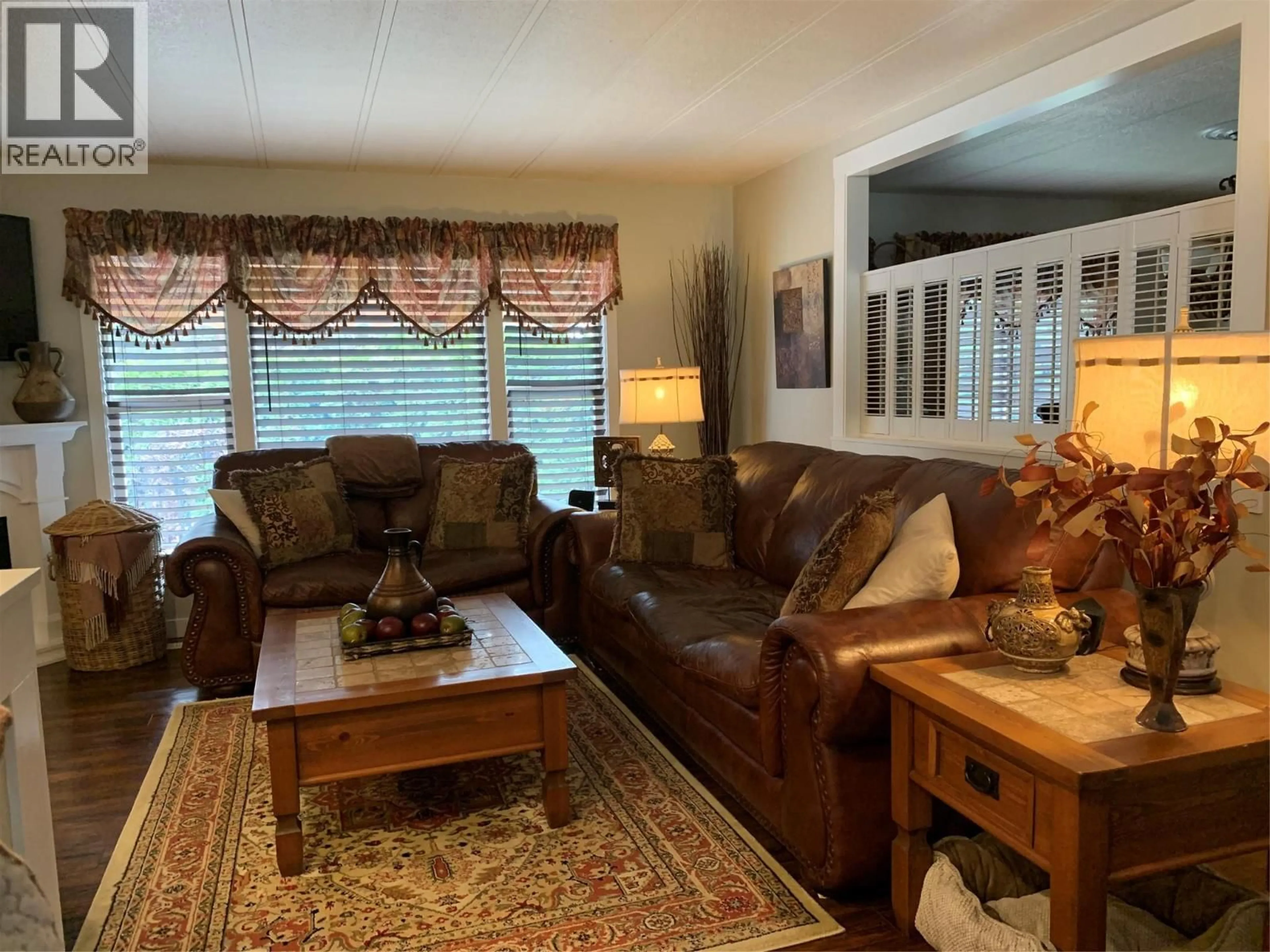 Living room with furniture, wood/laminate floor for 201 - 1999 HWY 97 OTHER, West Kelowna British Columbia V1Z1B2