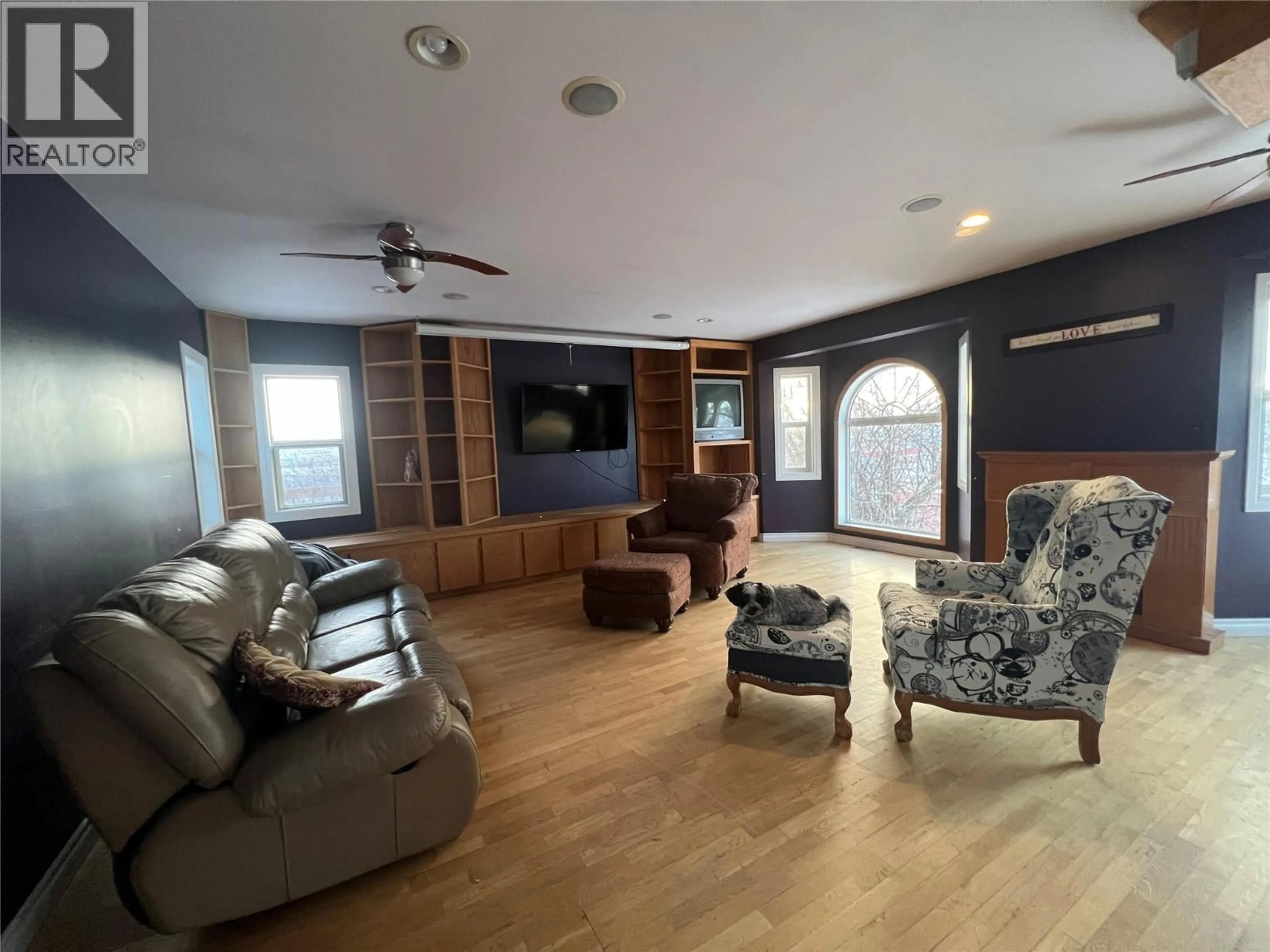 Living room with furniture, wood/laminate floor for 705 100A AVENUE, Dawson Creek British Columbia V1G1X8