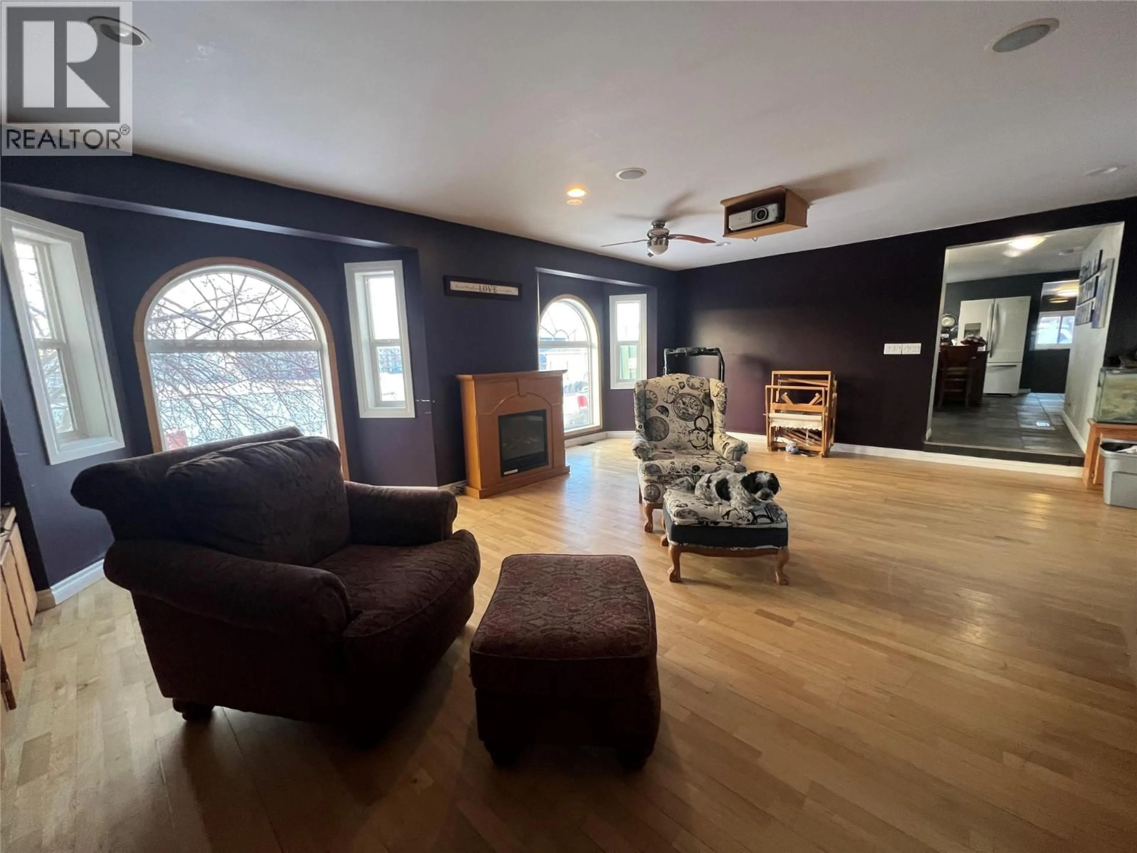 Living room with furniture, wood/laminate floor for 705 100A AVENUE, Dawson Creek British Columbia V1G1X8