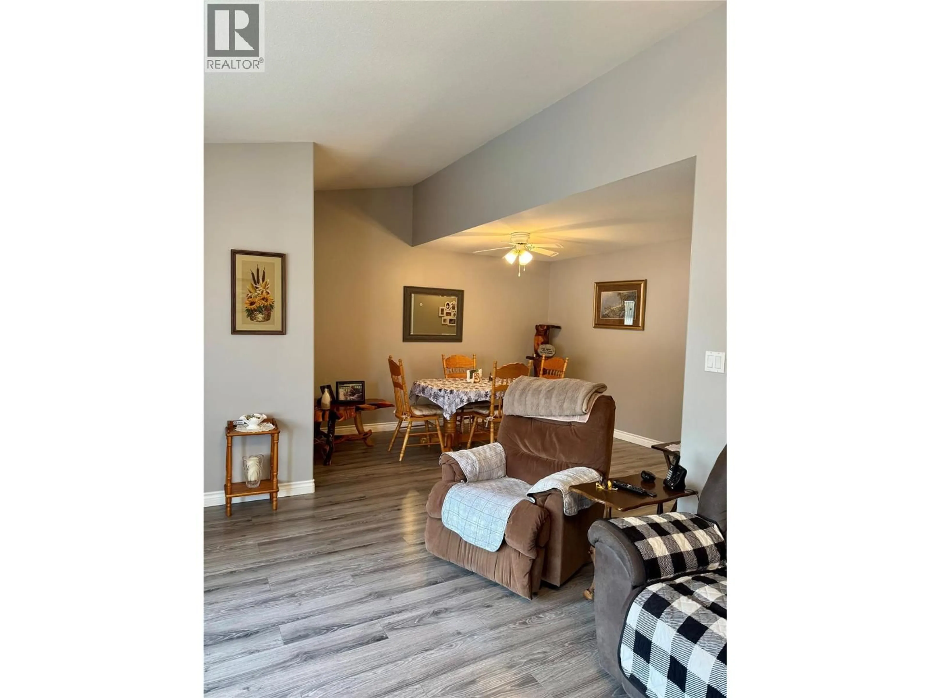 Living room with furniture, wood/laminate floor for 16 - 2760 VOGHT STREET, Merritt British Columbia V1K1C8