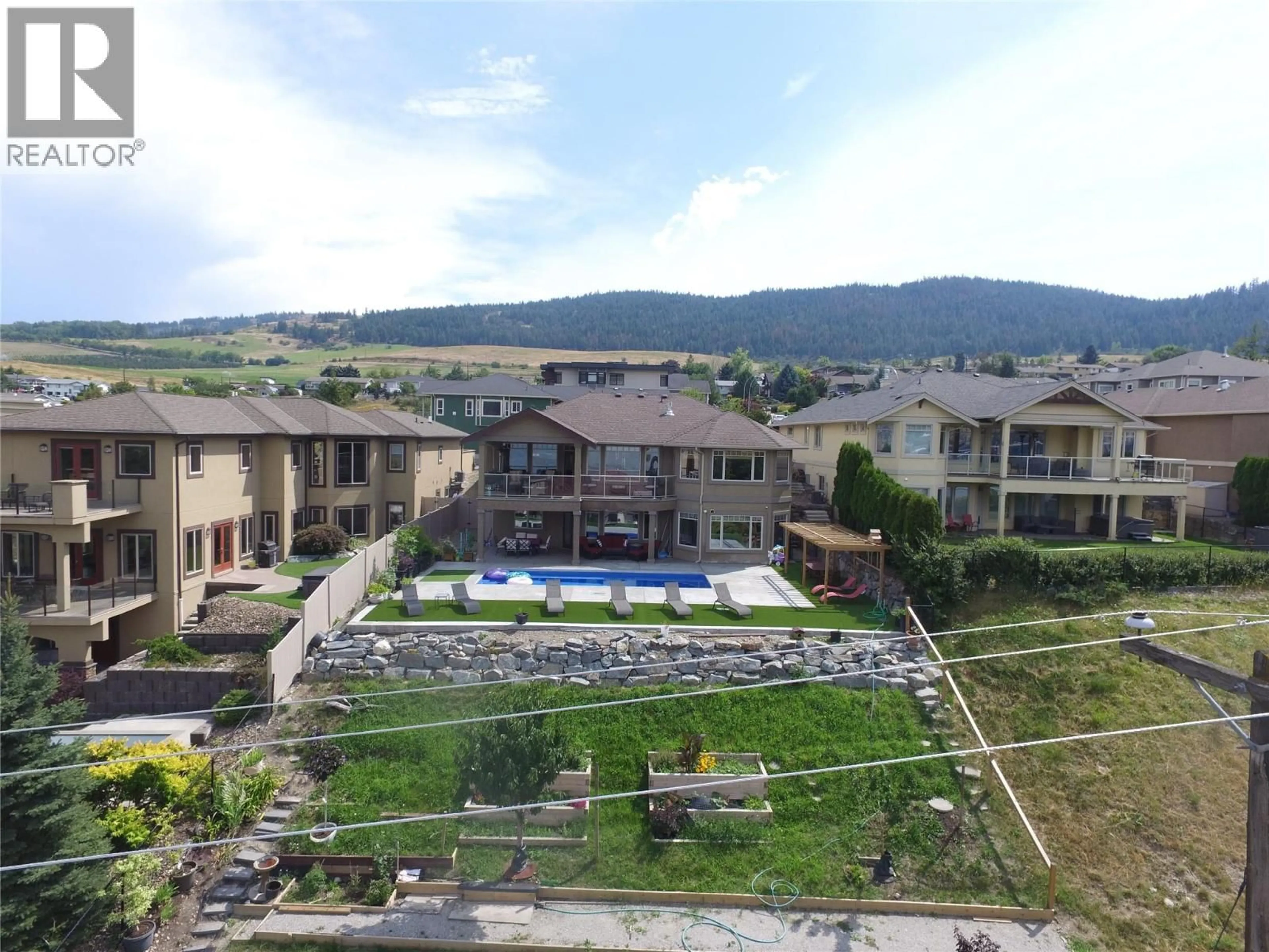A pic from outside/outdoor area/front of a property/back of a property/a pic from drone, mountain view for 1033 LONGACRE PLACE, Vernon British Columbia V1H1H7