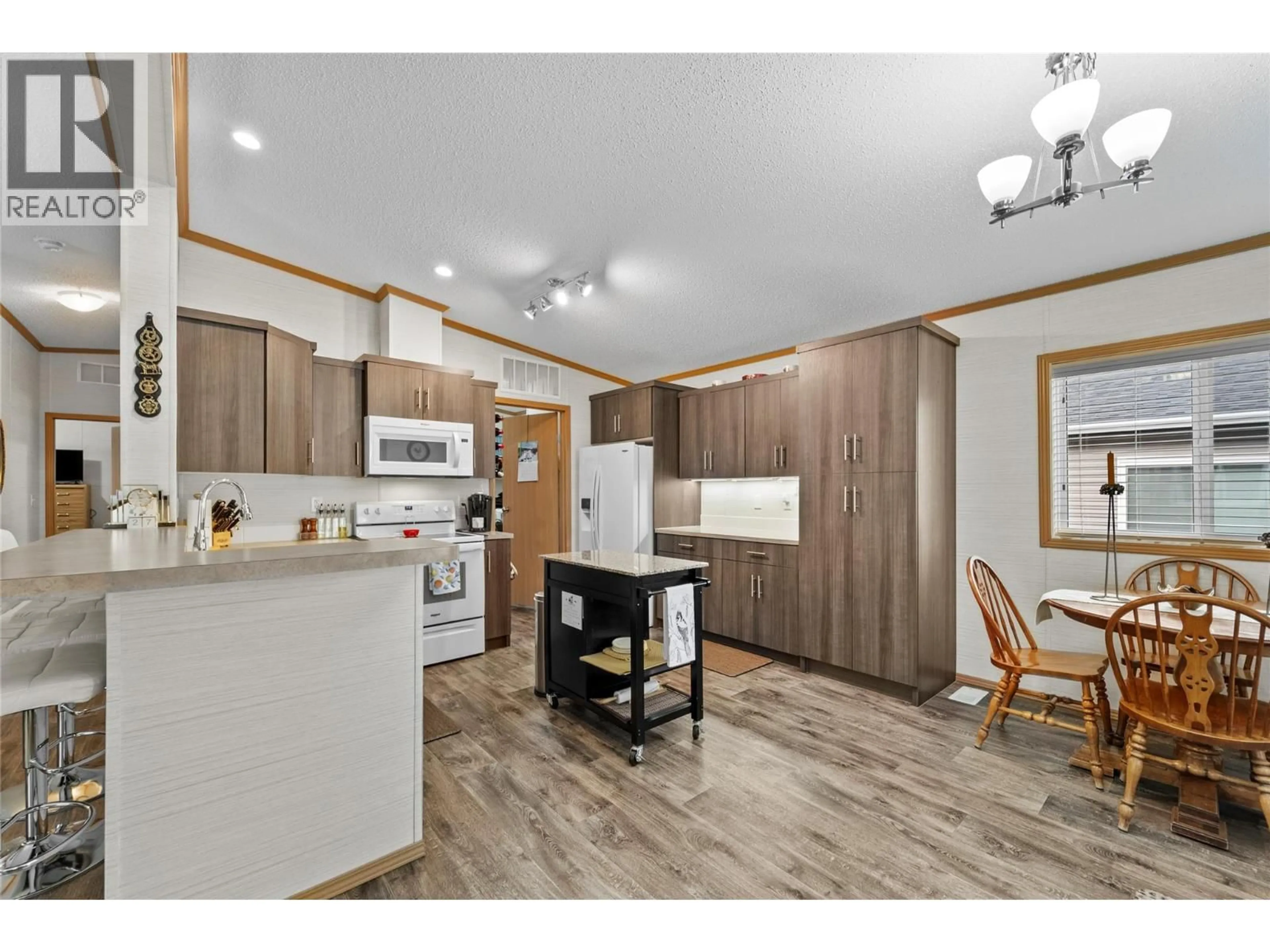 Open concept kitchen, wood/laminate floor for 52 - 7805 DALLAS DRIVE, Kamloops British Columbia V2C6X9