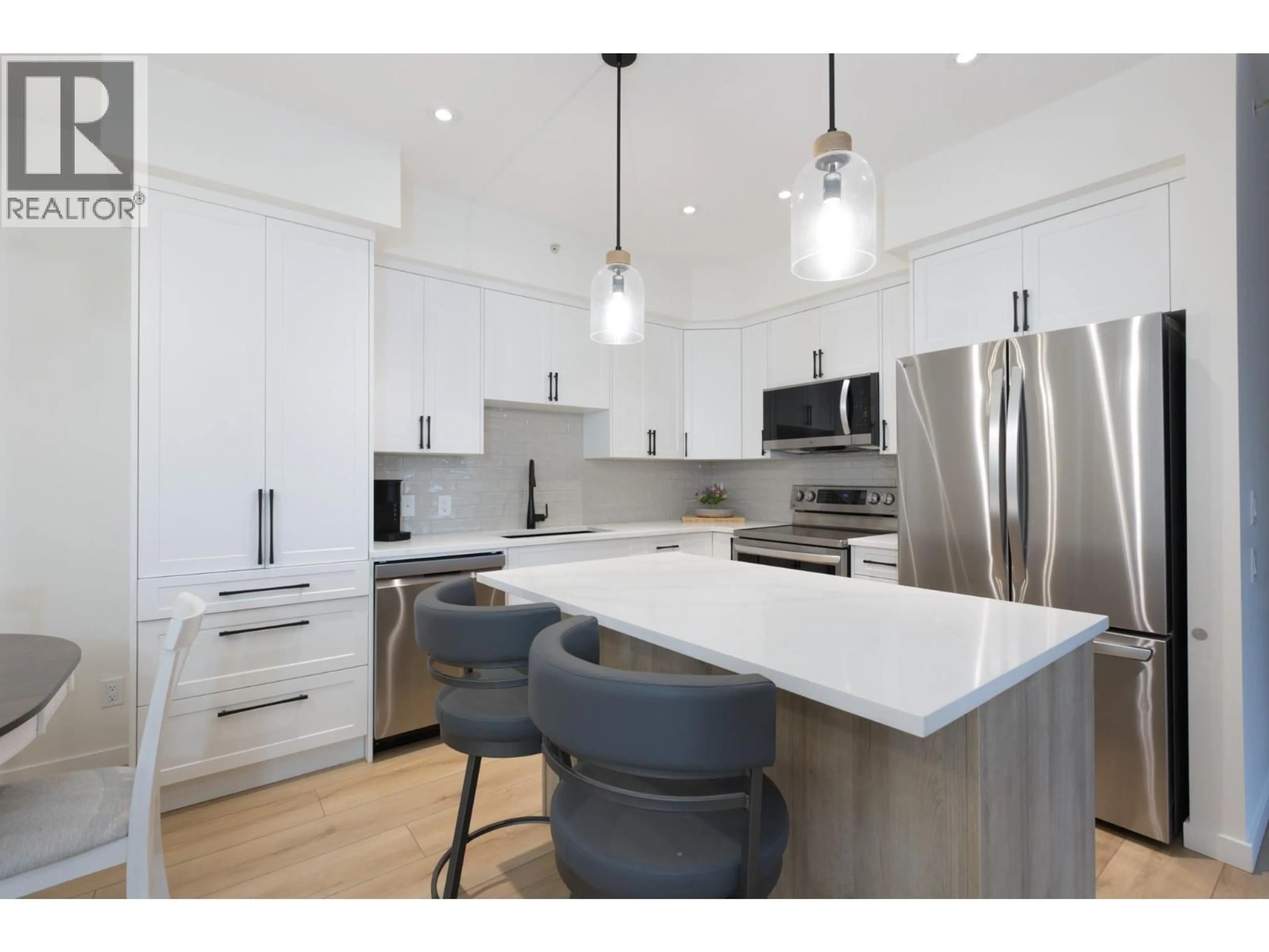 Open concept kitchen, wood/laminate floor for 400 - 680 LEQUIME ROAD, Kelowna British Columbia V1A1A4