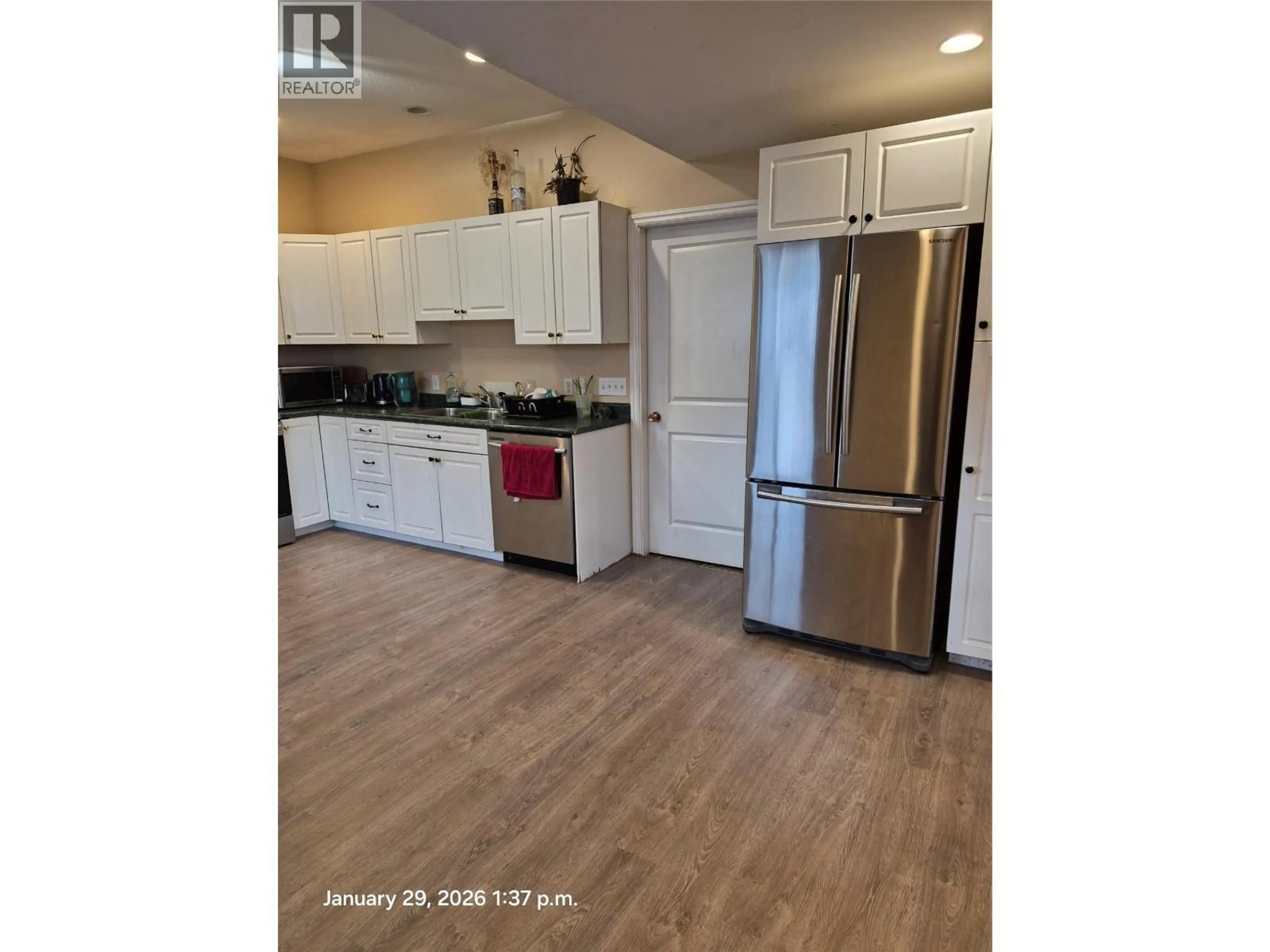 Open concept kitchen, wood/laminate floor for A + B - 1421 PINE STREET, Merritt British Columbia V1K1K5