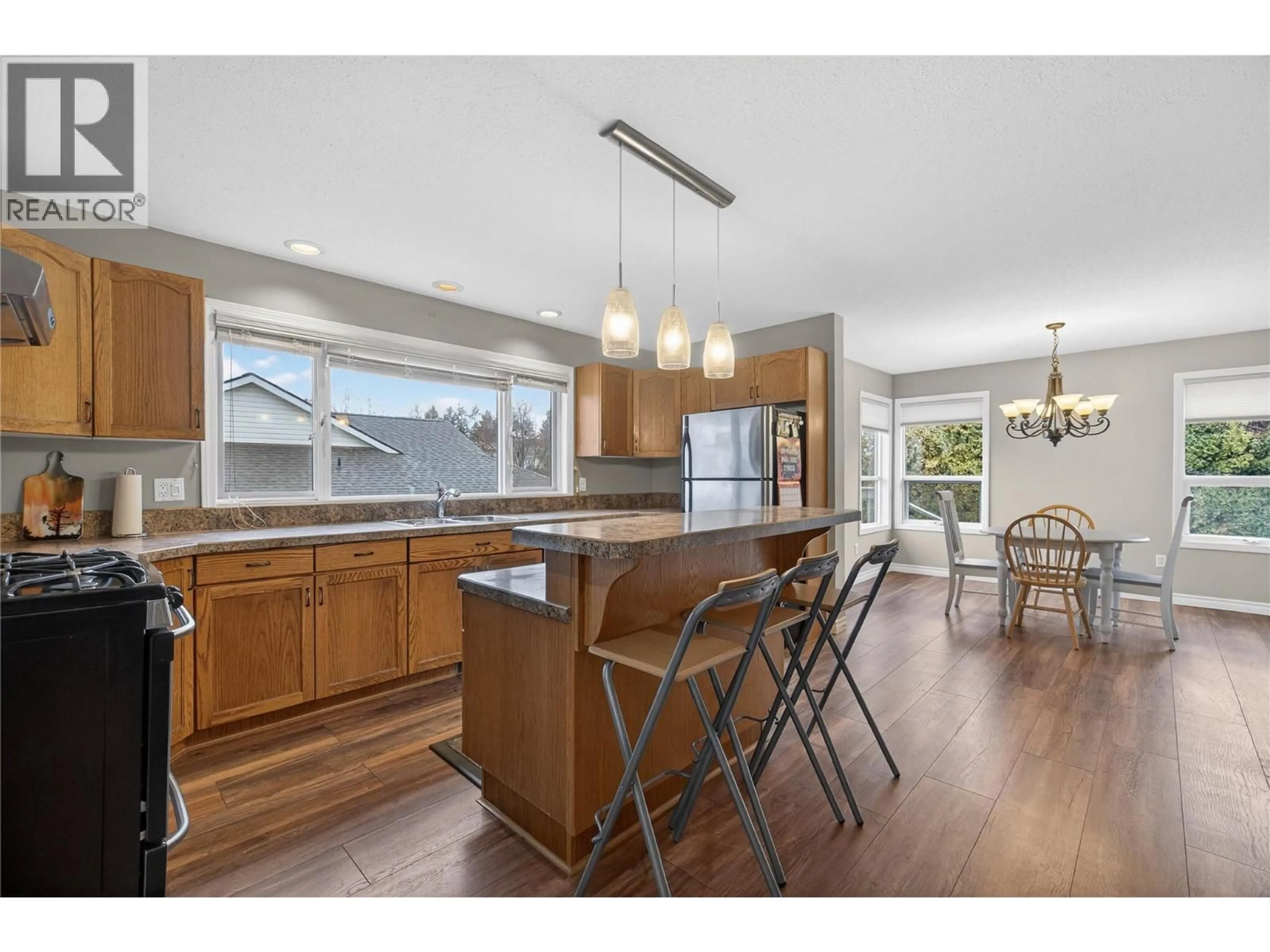 Open concept kitchen, wood/laminate floor for 4851 13 STREET NORTHEAST, Salmon Arm British Columbia V1E3P1