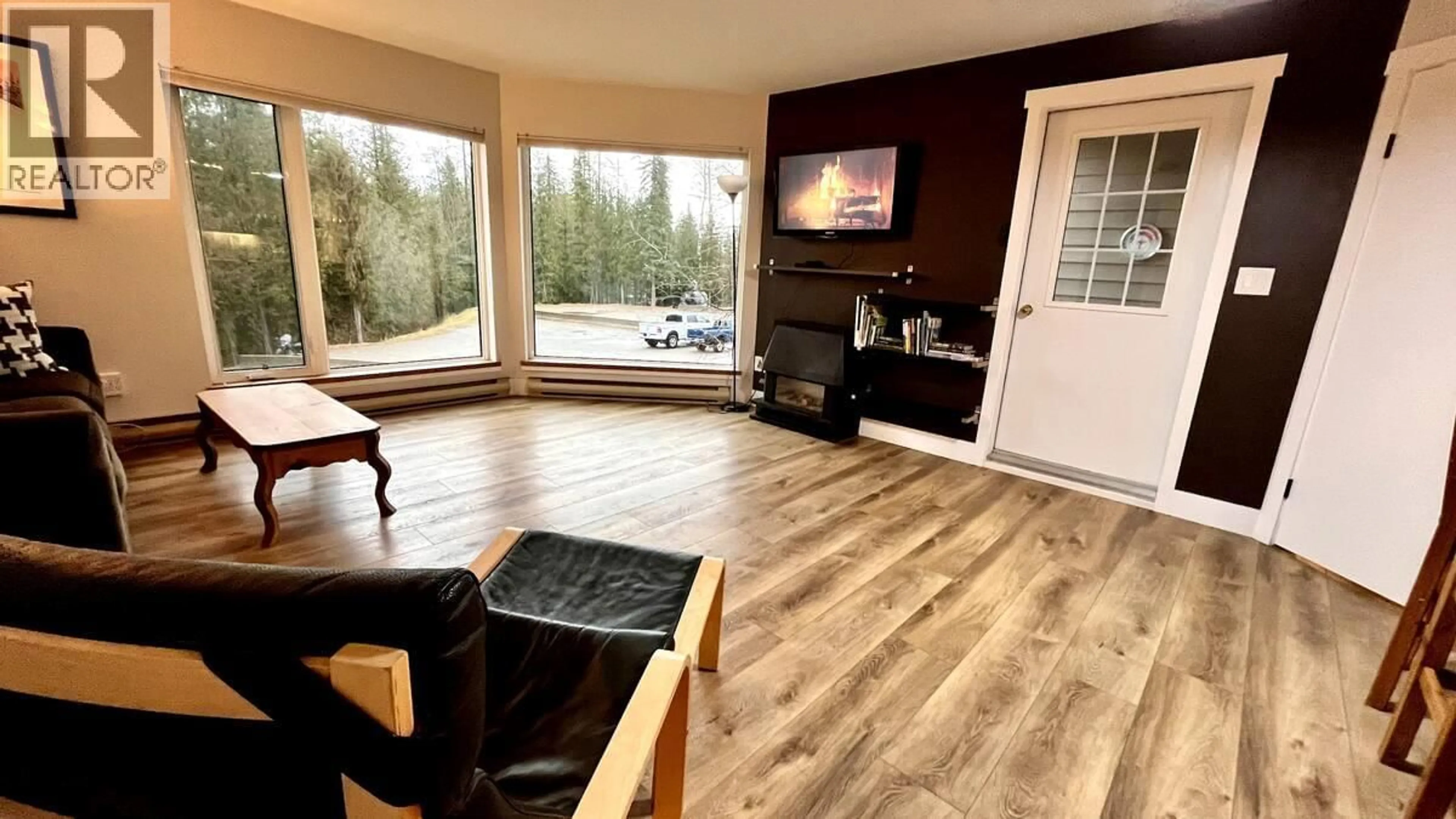 Living room with furniture, wood/laminate floor for 113 - 4559 TIMBERLINE CRESCENT, Fernie British Columbia V0B1M6