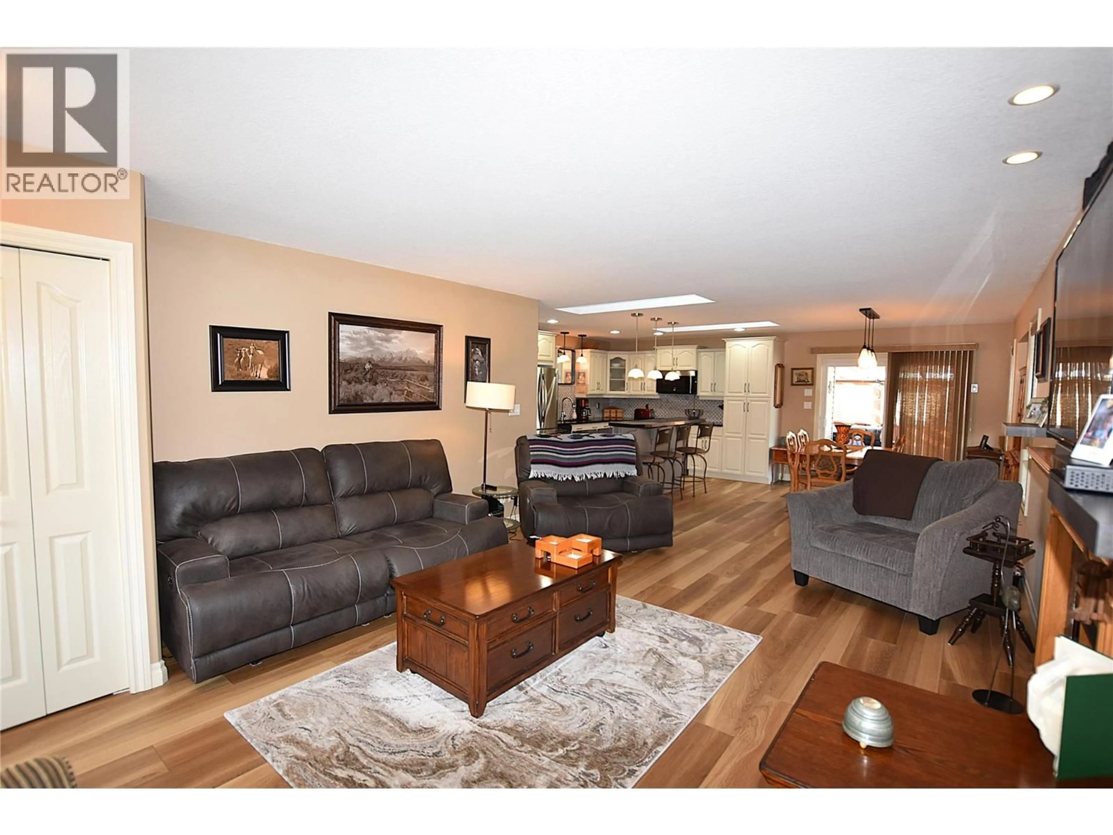 Living room with furniture, wood/laminate floor for 519 LOON AVENUE, Vernon British Columbia V1H2A1