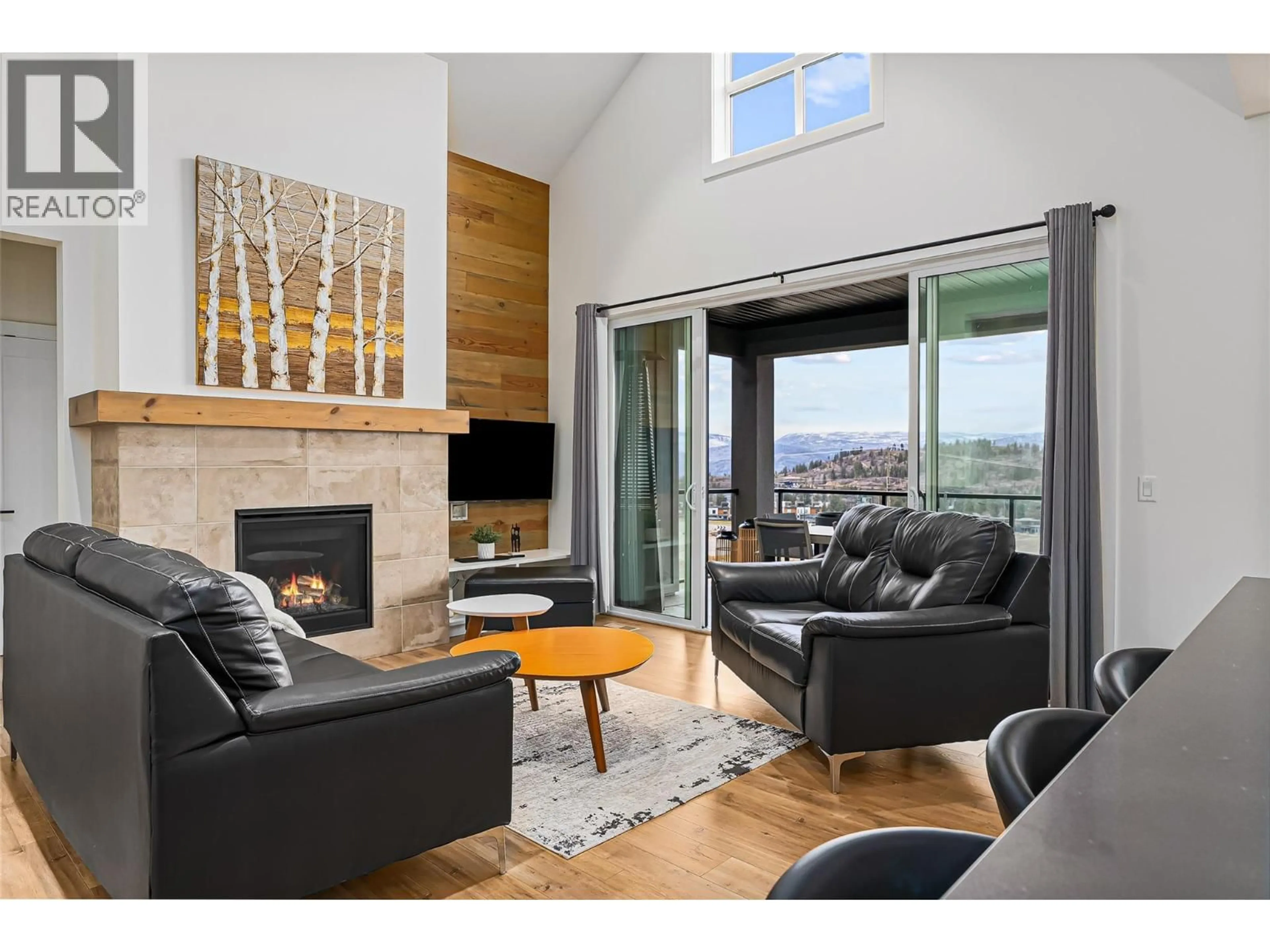Living room with furniture, wood/laminate floor for 209 ASHCROFT PLACE, Vernon British Columbia V1H2M1