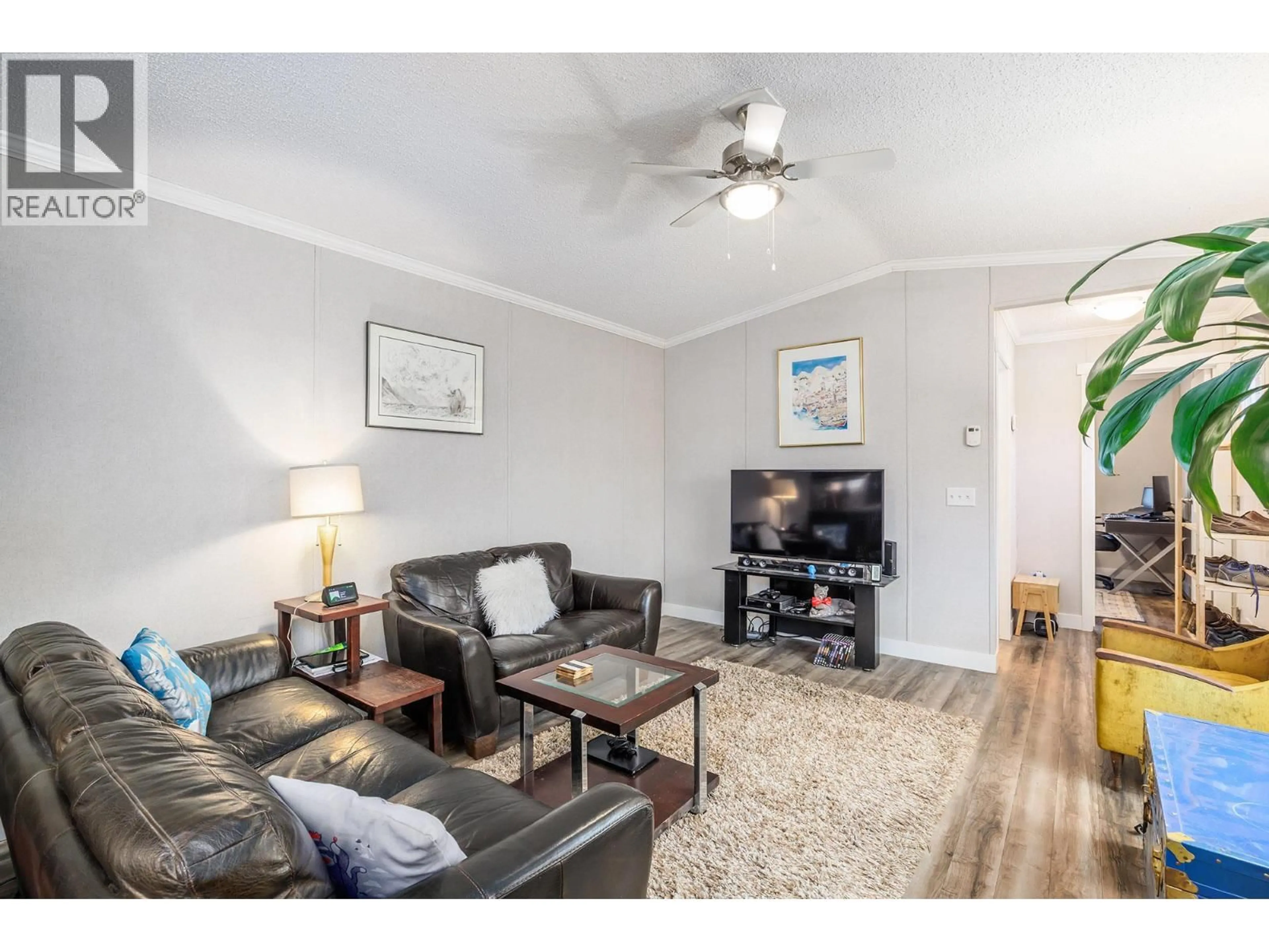 Living room with furniture, wood/laminate floor for 74 - 8945 HIGHWAY 97N OTHER, Kelowna British Columbia V4V2E8