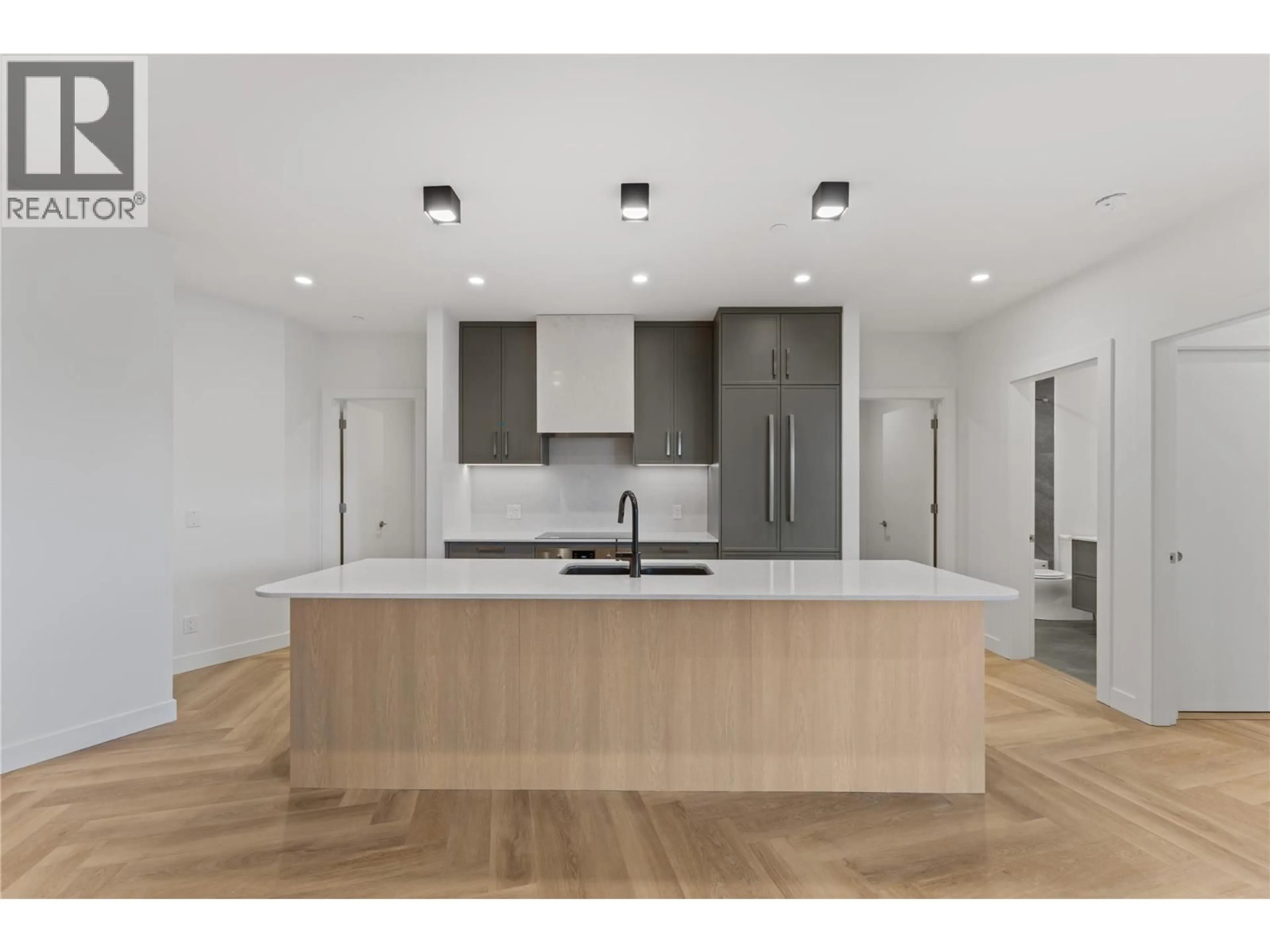 Open concept kitchen, wood/laminate floor for 414 - 3340 LAKESHORE DRIVE, Kelowna British Columbia V1W0H6