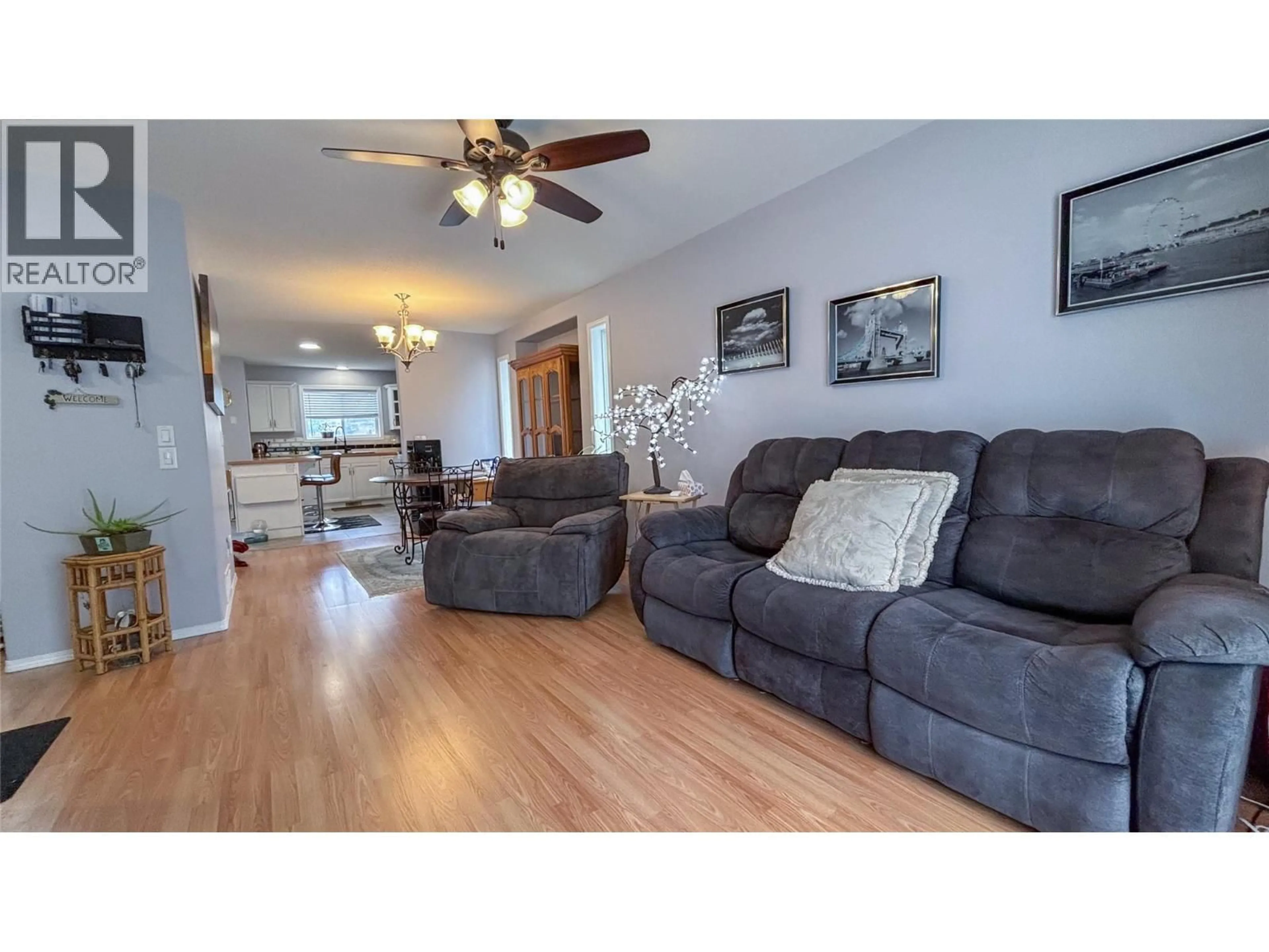 Living room with furniture, wood/laminate floor for 512 RED WING DRIVE, Penticton British Columbia V2A8K6
