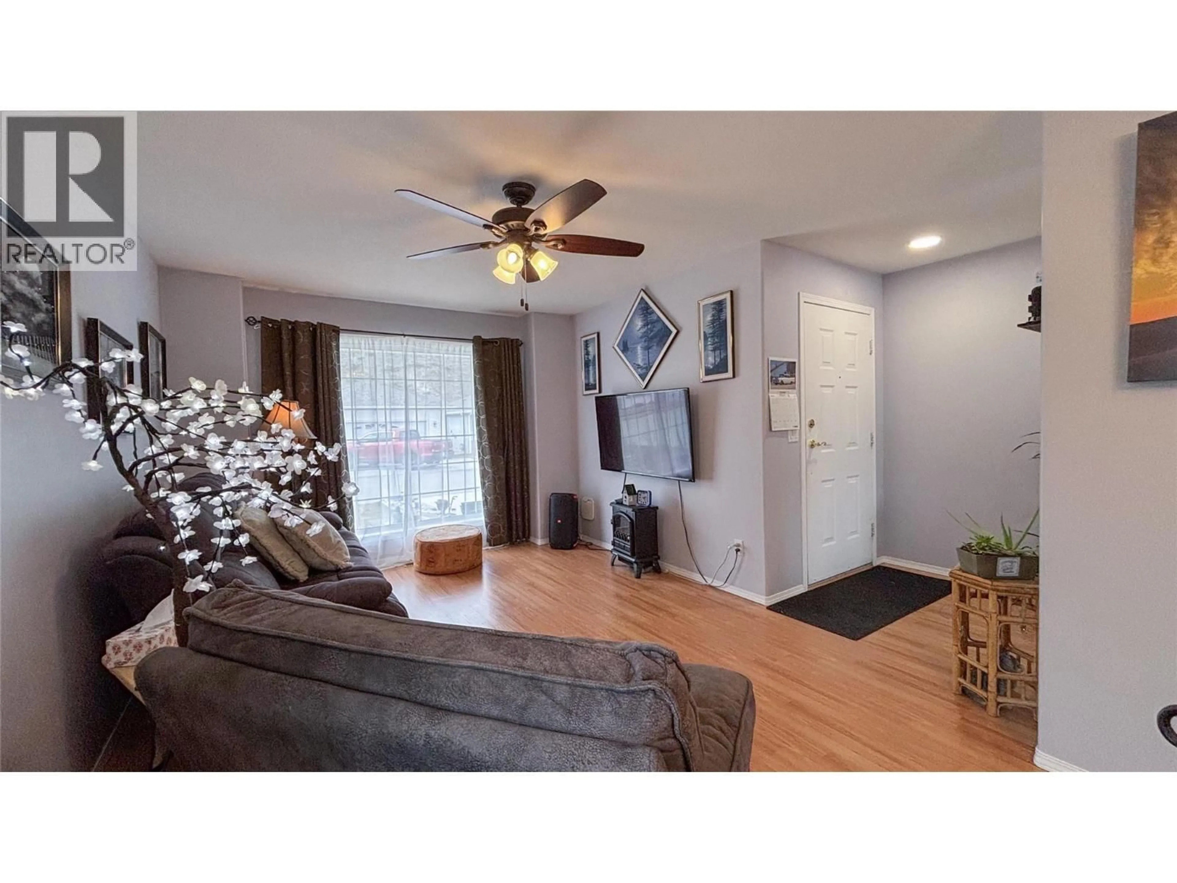 Living room with furniture, wood/laminate floor for 512 RED WING DRIVE, Penticton British Columbia V2A8K6