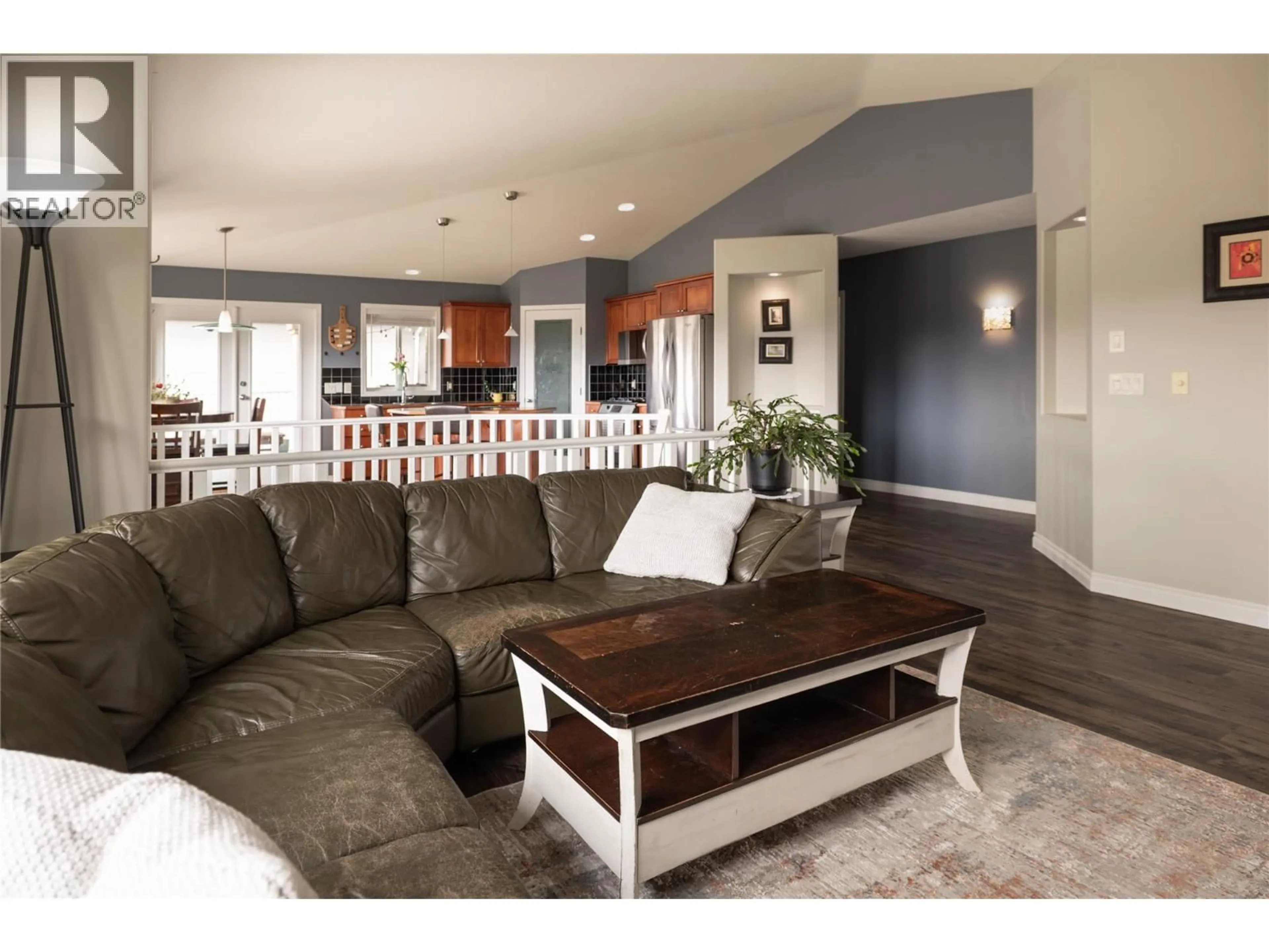 Living room with furniture, wood/laminate floor for 3013 BRINDISI PLACE, Kelowna British Columbia V1V2N5