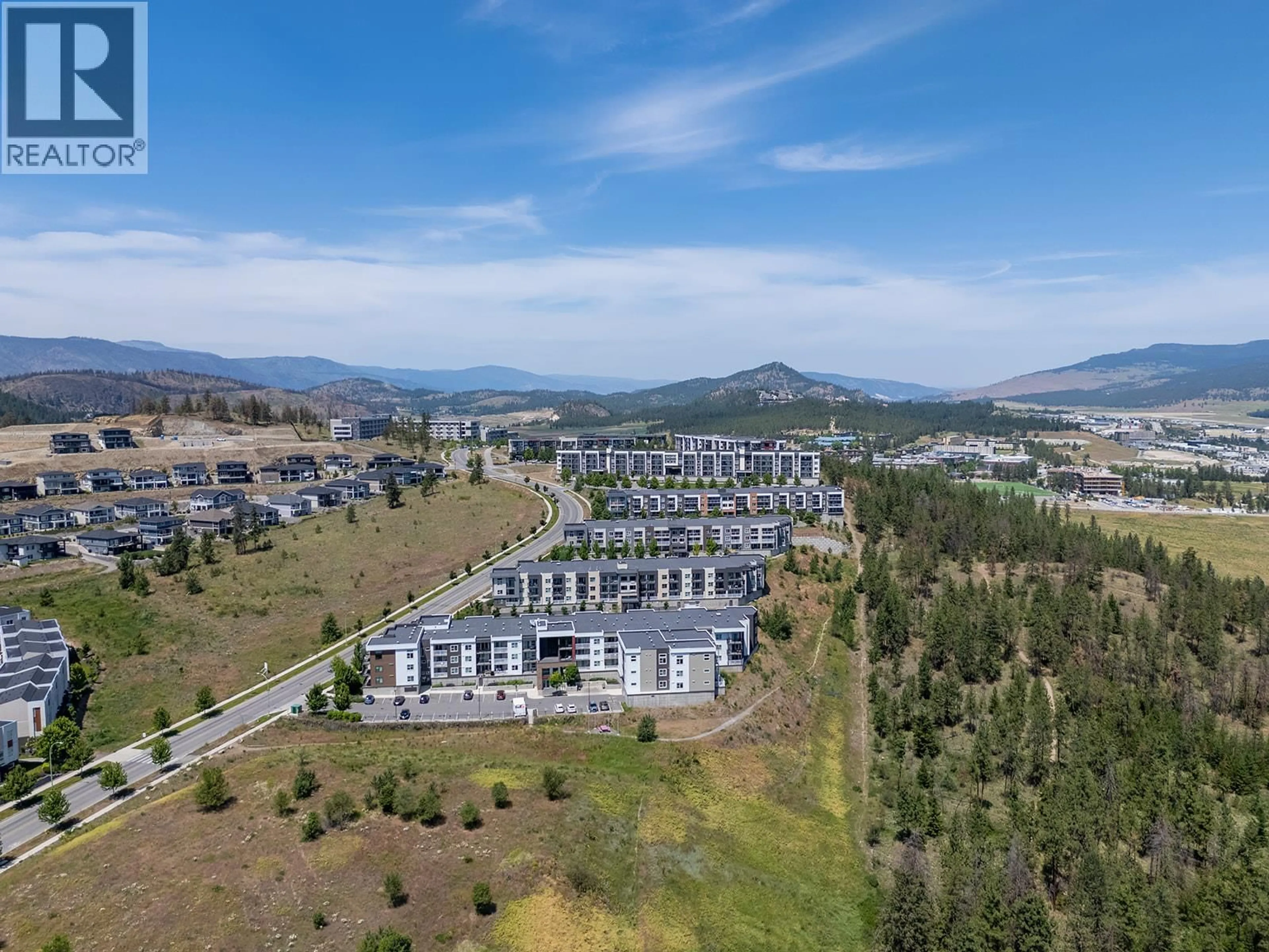 A pic from outside/outdoor area/front of a property/back of a property/a pic from drone, mountain view for 203 - 625 ACADEMY WAY, Kelowna British Columbia V1V0E3