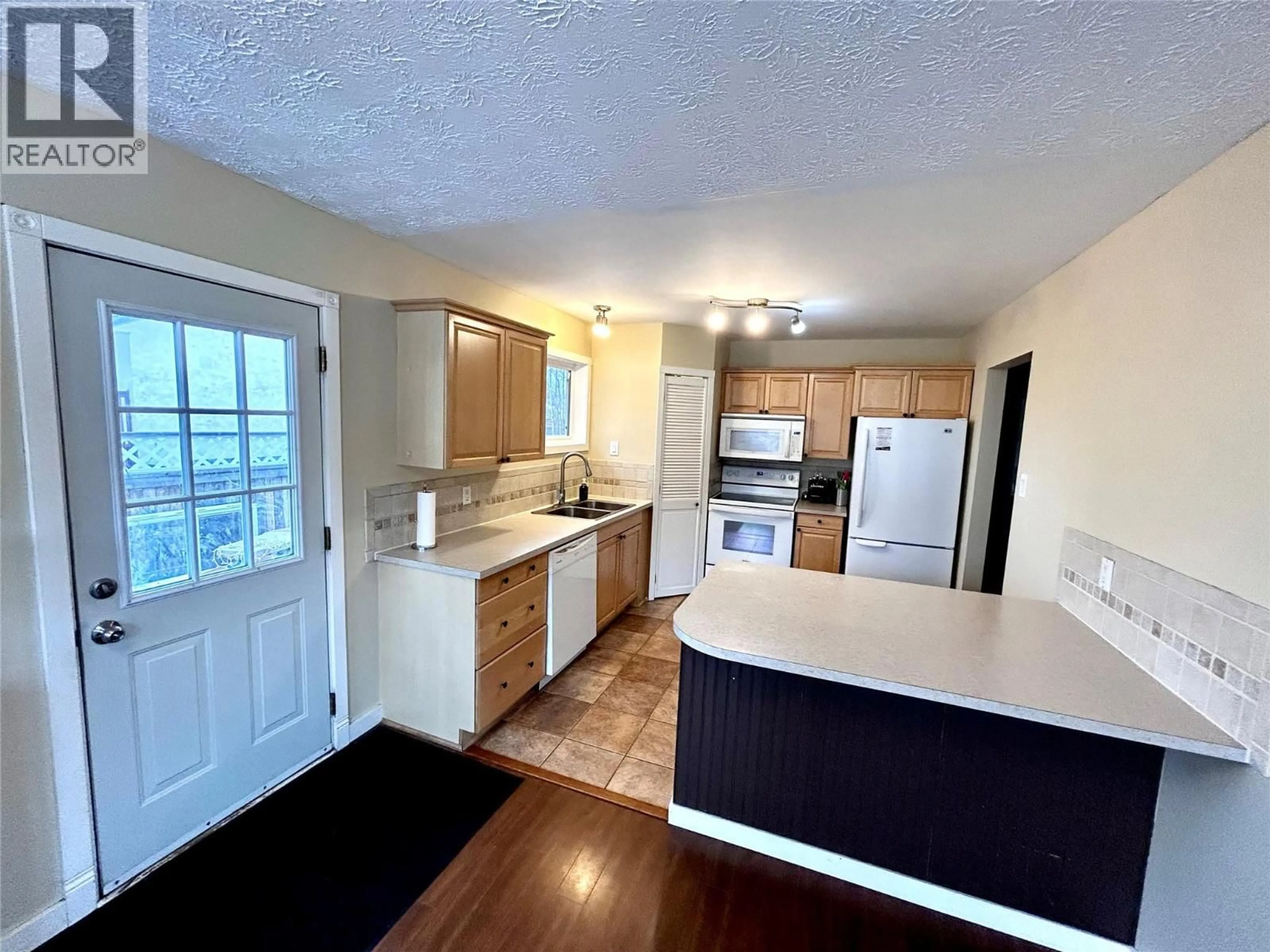 Open concept kitchen, wood/laminate floor for 404 WILLOW DRIVE, Tumbler Ridge British Columbia V0C2W0