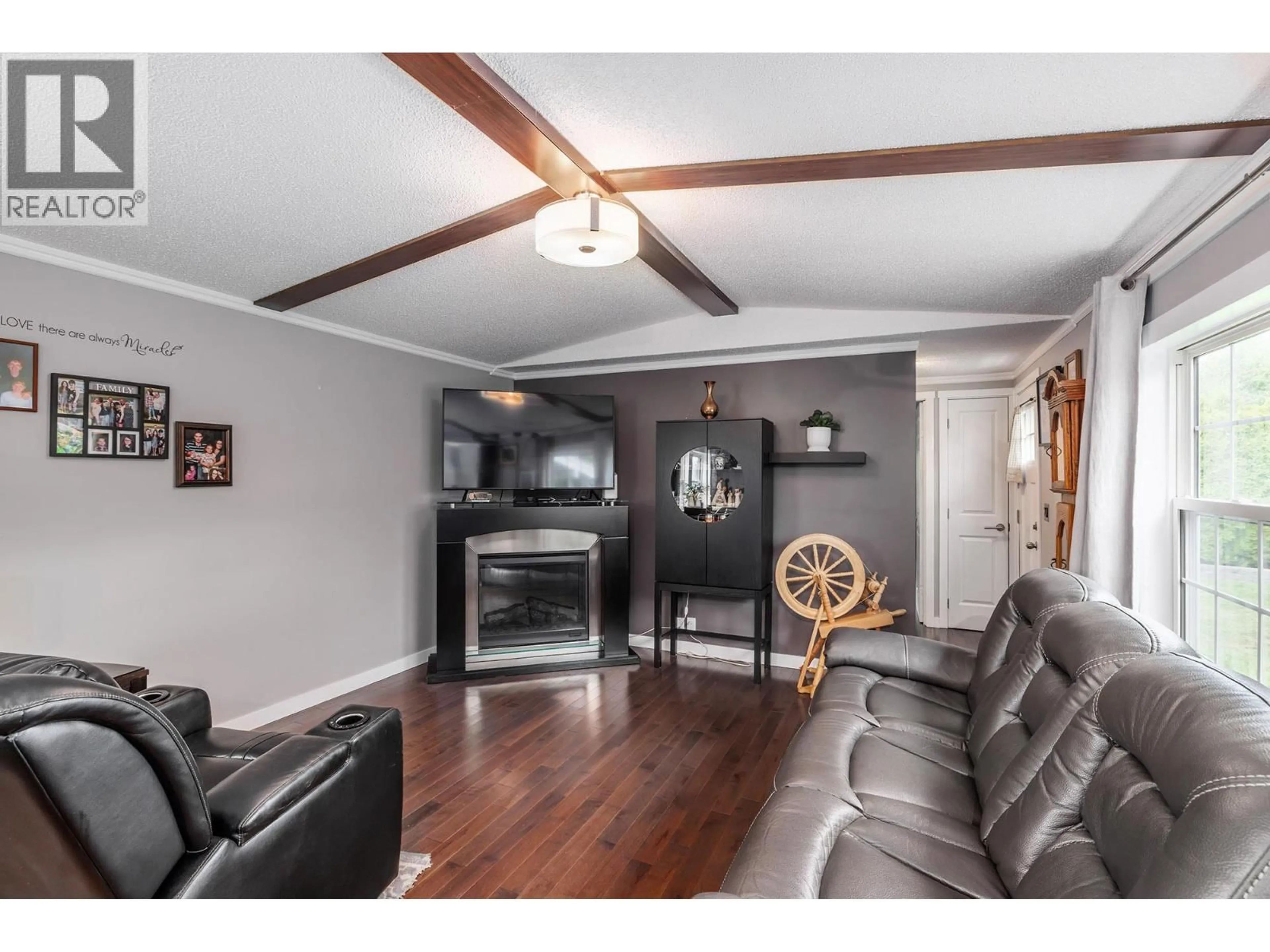 Living room with furniture, wood/laminate floor for 70 - 3381 VILLAGE GREEN WAY, Westbank British Columbia V4T1L2