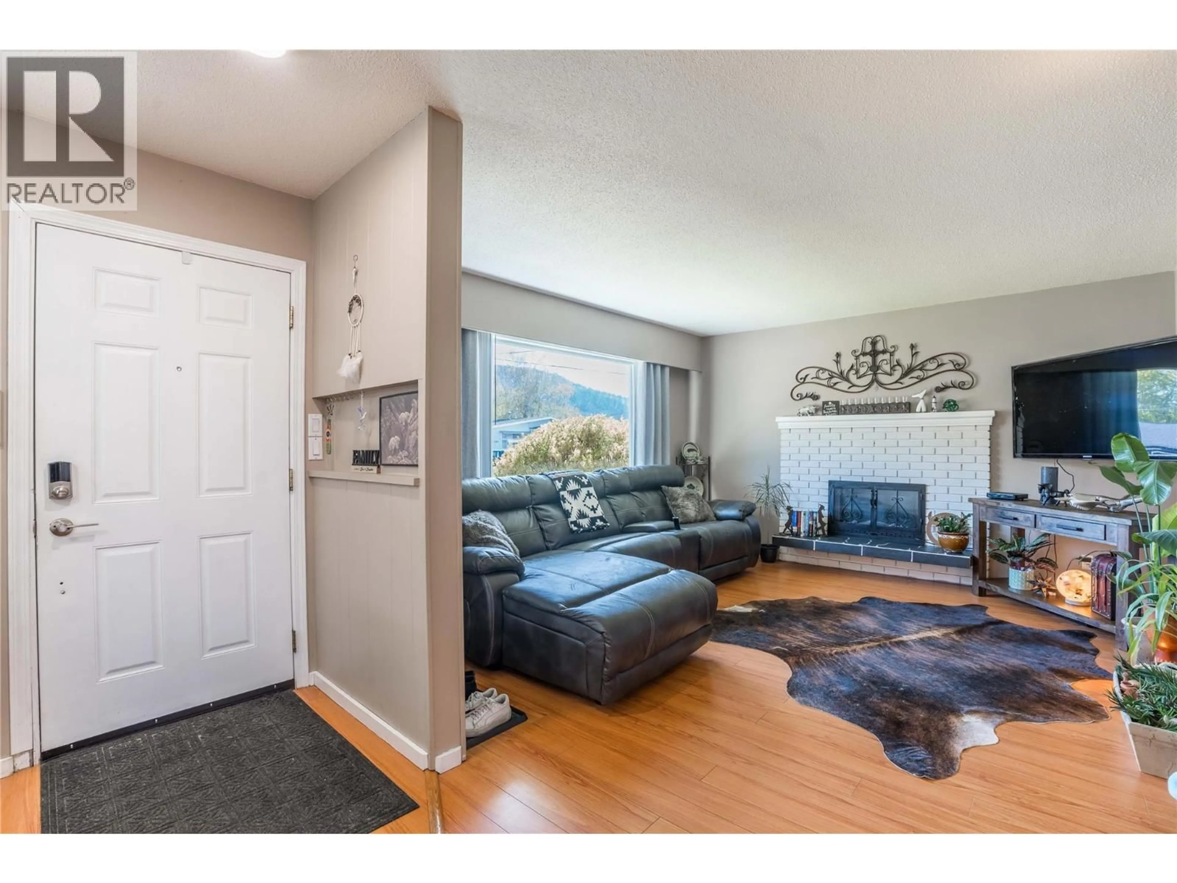 Living room with furniture, wood/laminate floor for 12240 SAUNDERS CRESCENT, Summerland British Columbia V0H1Z0