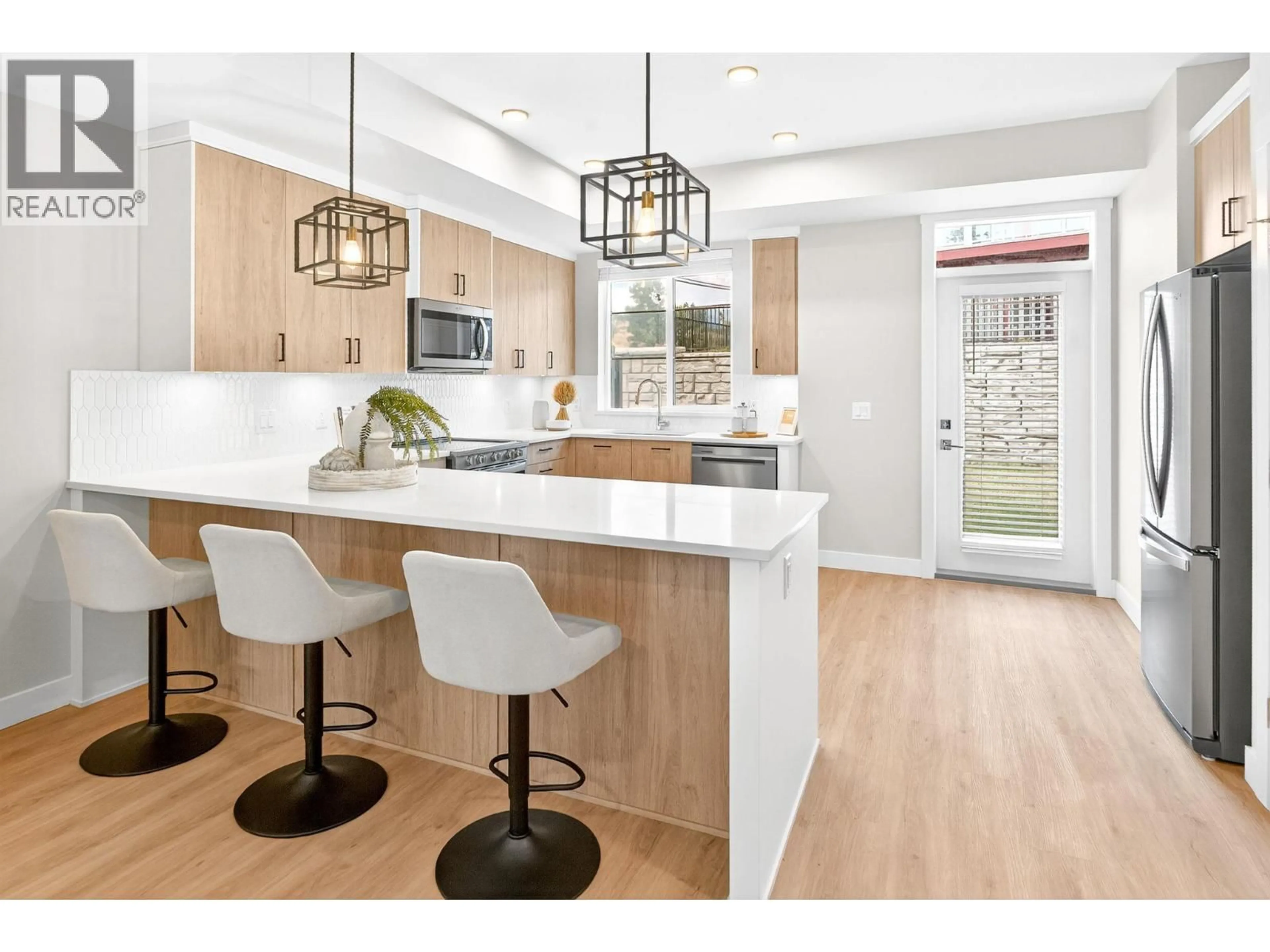 Open concept kitchen, wood/laminate floor for 192 - 4025 GELLATLY ROAD SOUTH, West Kelowna British Columbia V4T0E6