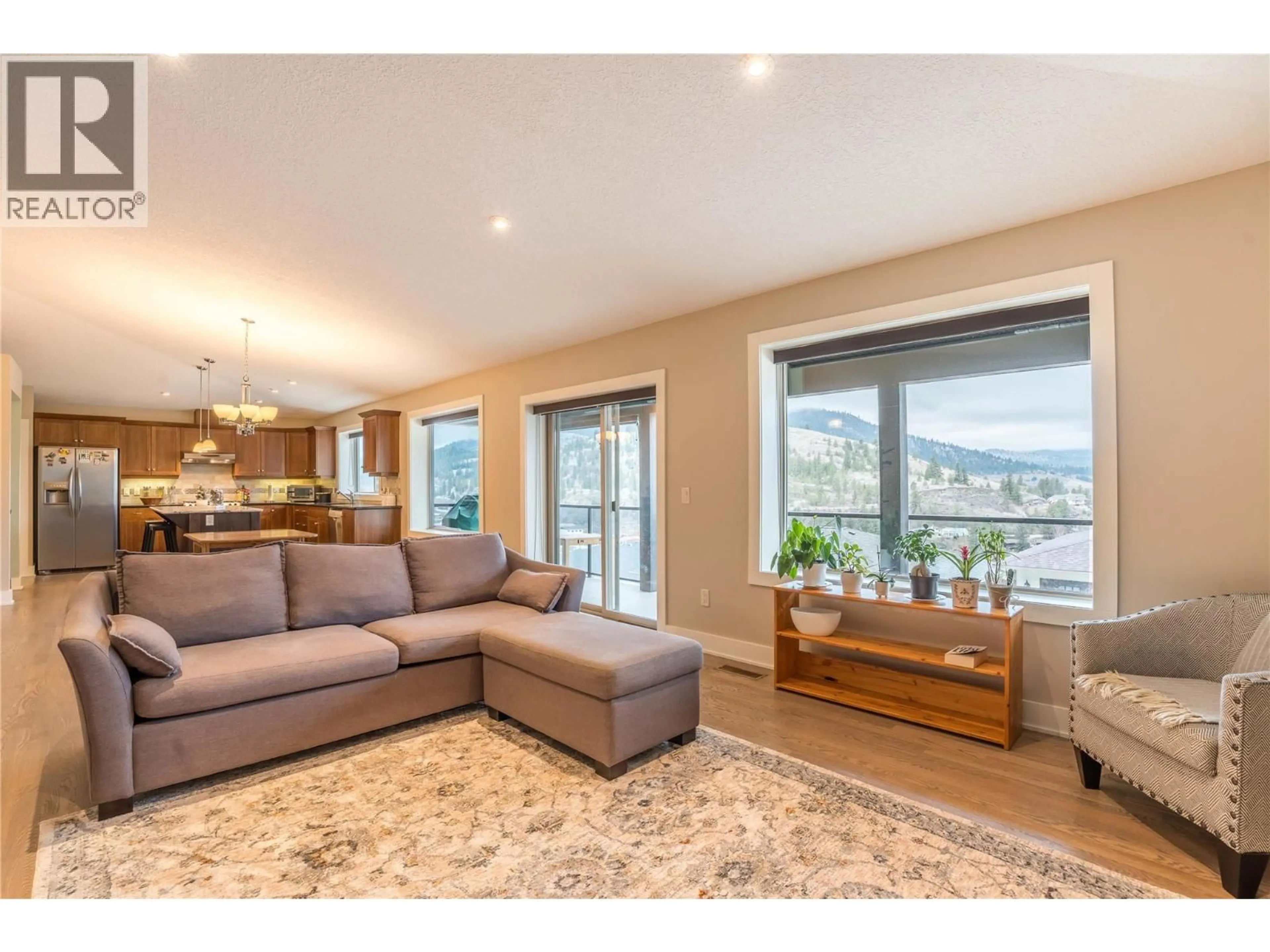 Living room with furniture, wood/laminate floor for 15 - 10605 CEDAR AVENUE, Summerland British Columbia V0H1Z2