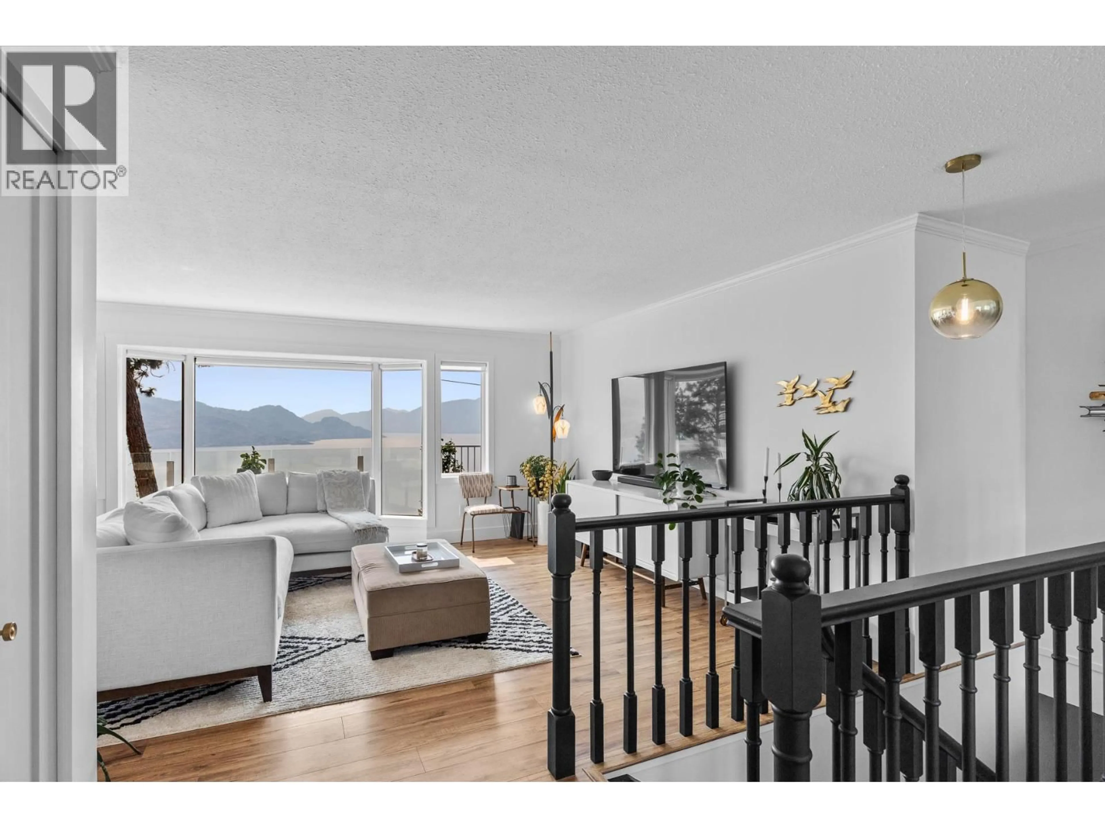 Living room with furniture, wood/laminate floor for 4215 6 AVENUE, Peachland British Columbia V0H1X5