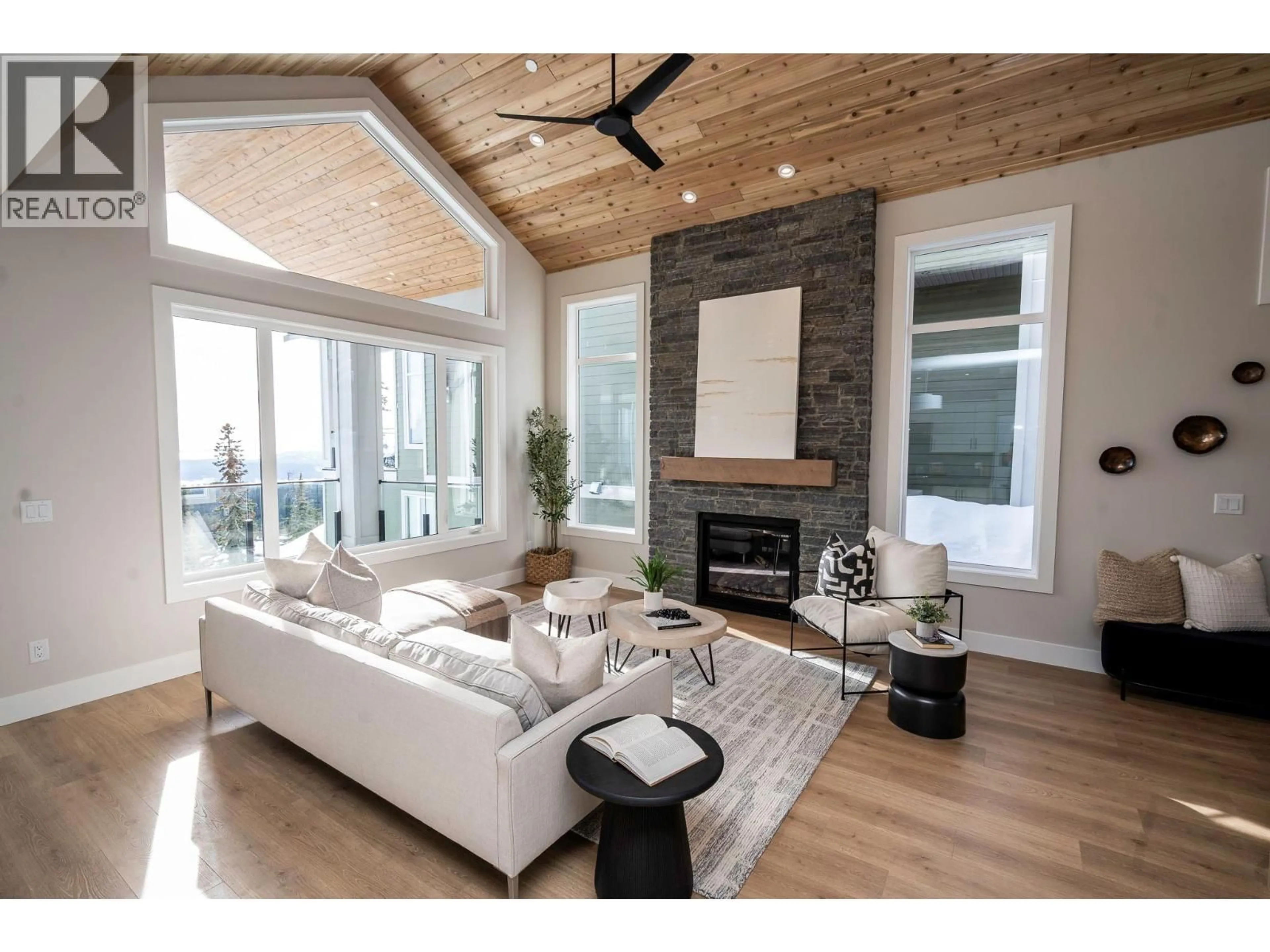 Living room with furniture, wood/laminate floor for 215A GRIZZLY RIDGE TRAIL, Big White British Columbia V1P1P4