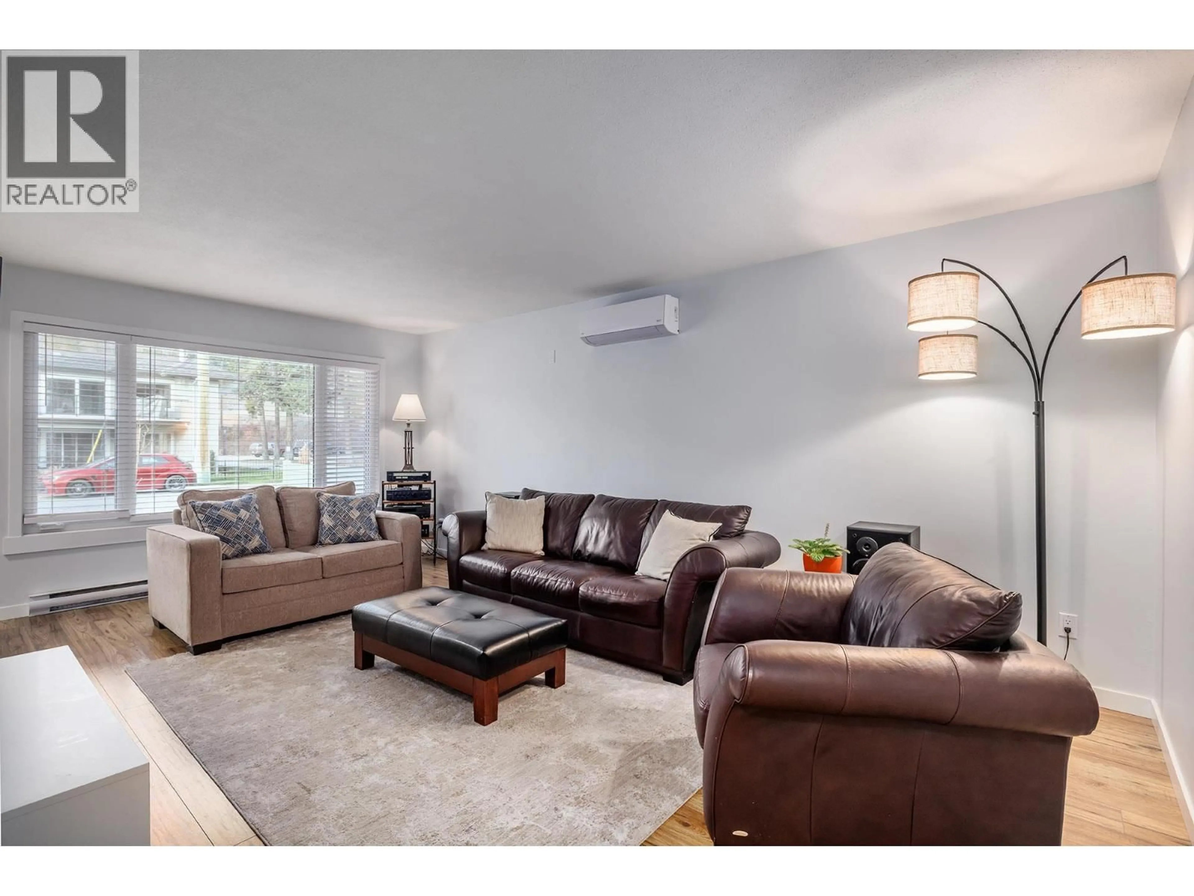 Living room with furniture, wood/laminate floor for 4391 11TH STREET, Peachland British Columbia V0X1X6