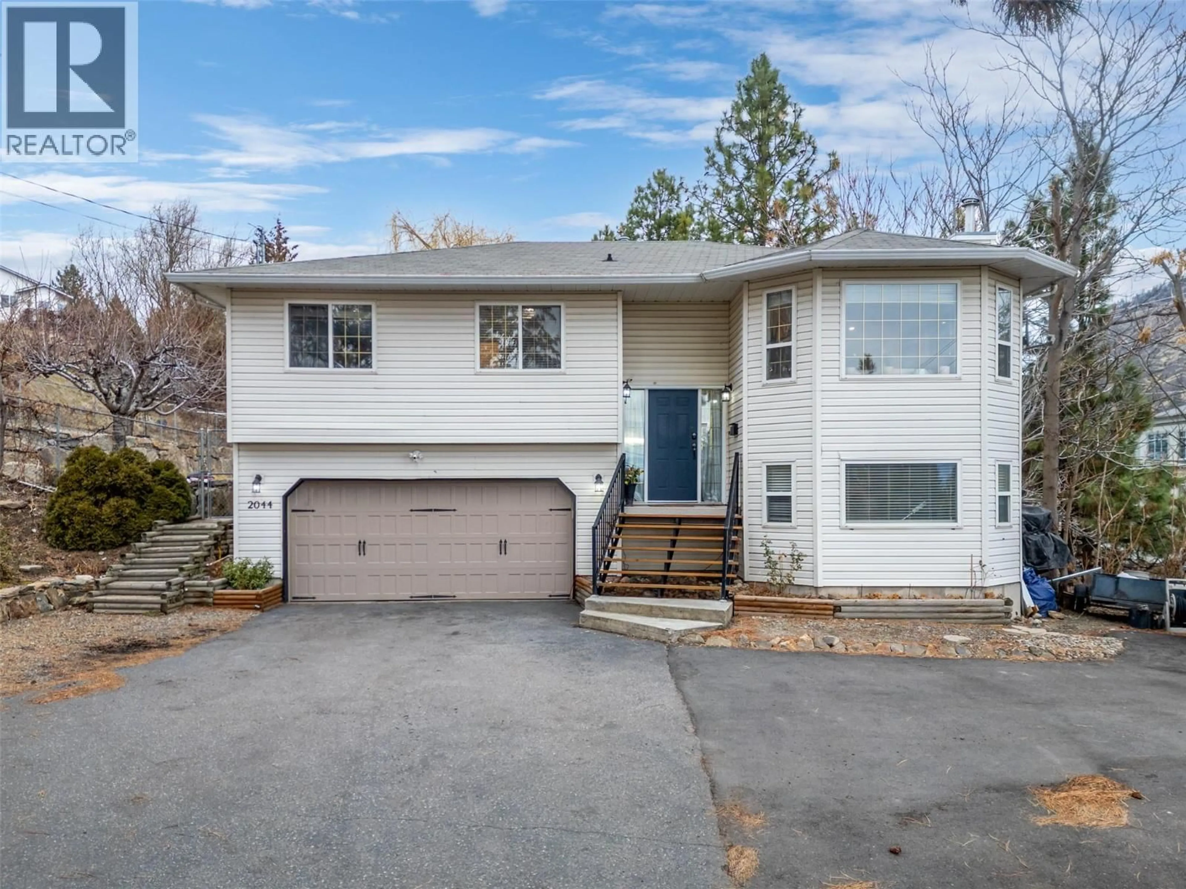 Home with vinyl exterior material, street for 2044 OLD OKANAGAN HIGHWAY, West Kelowna British Columbia V4T1T8